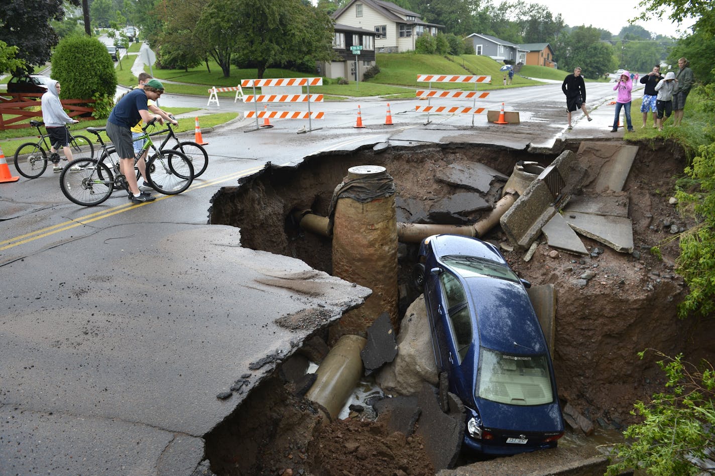 Roads collapsed into sinkholes in the Duluth area. A car was pulled into this sinkhole along Skyline Parkway.