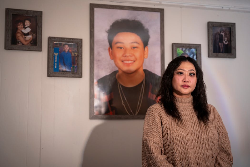 Baky Mikaele posed for a portrait in front of photographs of her son Jin Taylor at her home in Minneapolis on Jan. 16.