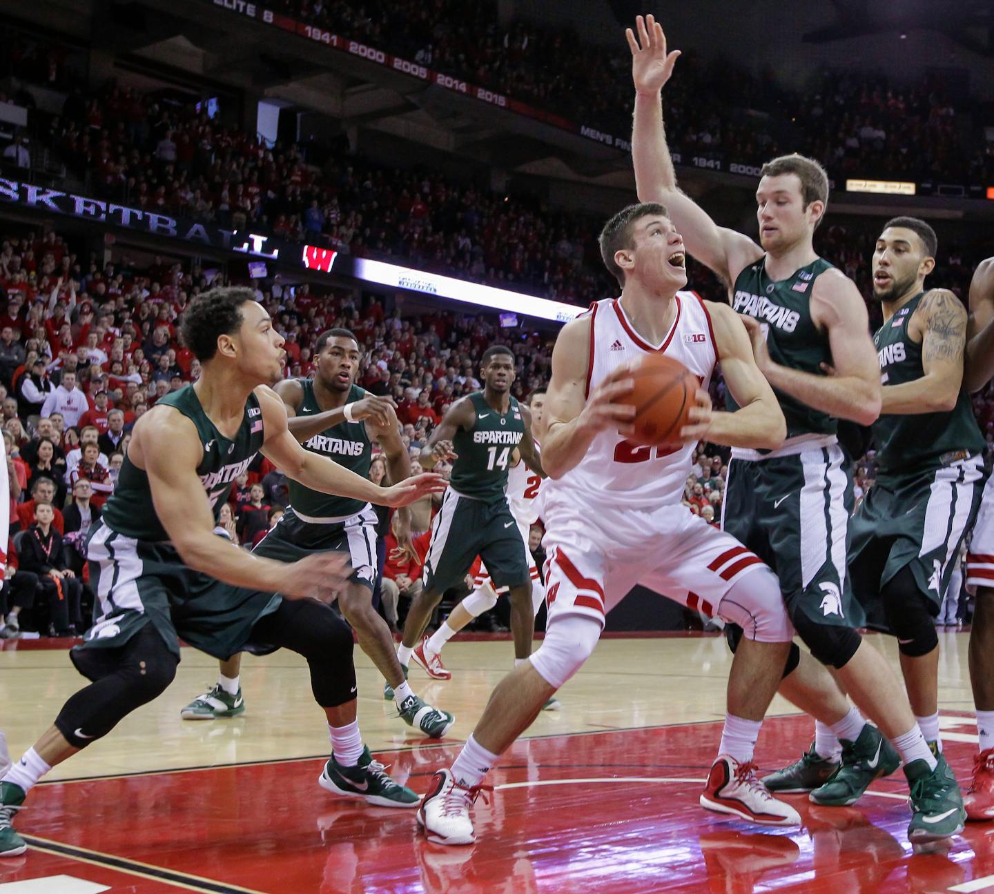 Wisconsin's Ethan Happ lined up his game-winning shot against Michigan State's Matt Costello, second from right, during the Badgers' 77-76 upset over Michigan State on Sunday.