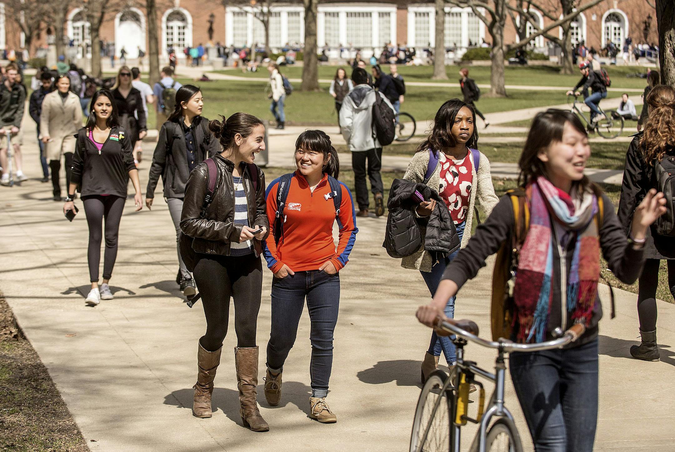 FILE - In this Oct. 28, 2015, file photo, students walk across the Quad on the University of Illinois campus in Urbana, Ill. College tuition may be daunting, but so are the conversations about how to pay for it. Experts say it pays off for parents talk with children early and often about how to cover higher education costs. (Heather Coit/The News-Gazette via AP)