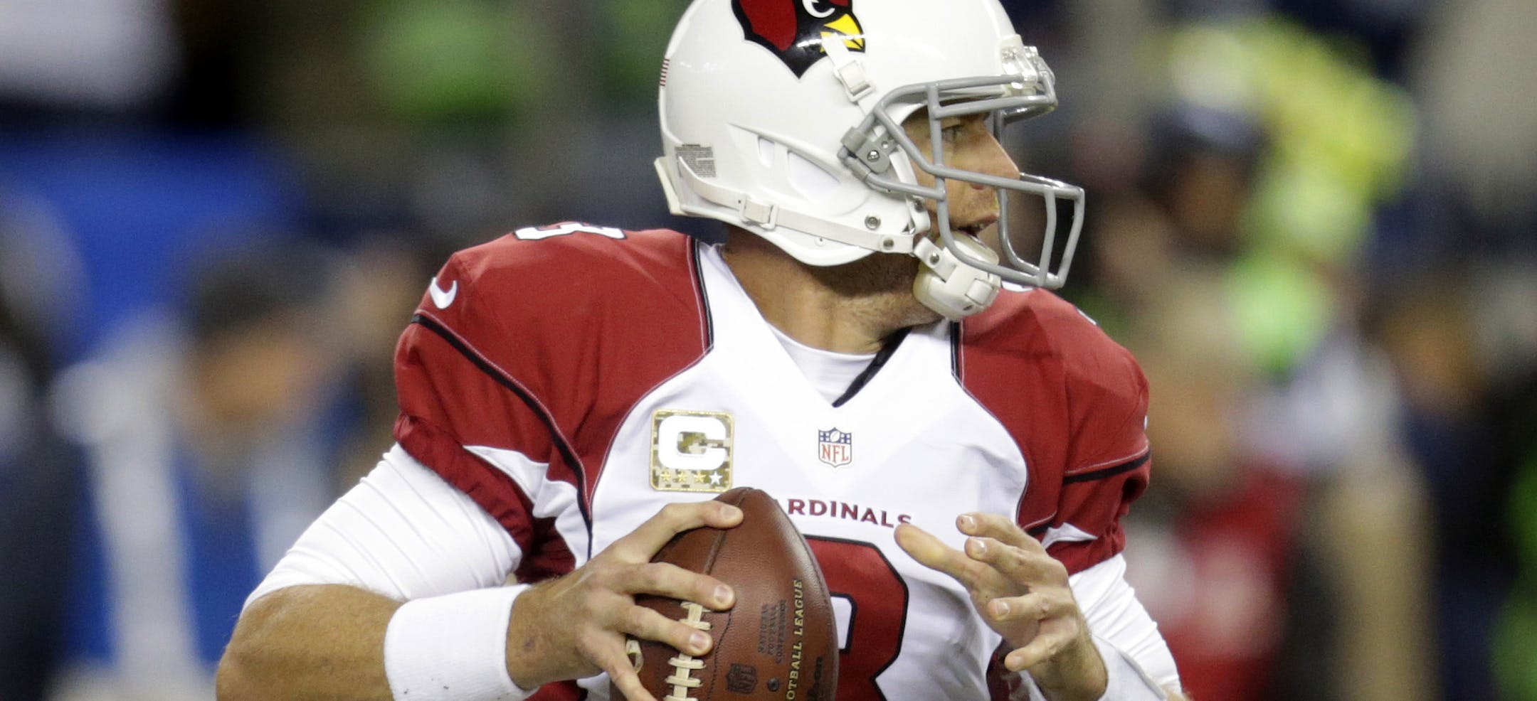 Arizona Cardinals quarterback Carson Palmer looks to pass in the first half of an NFL football game against the Seattle Seahawks, Sunday, Nov. 15, 2015, in Seattle. (AP Photo/Stephen Brashear)