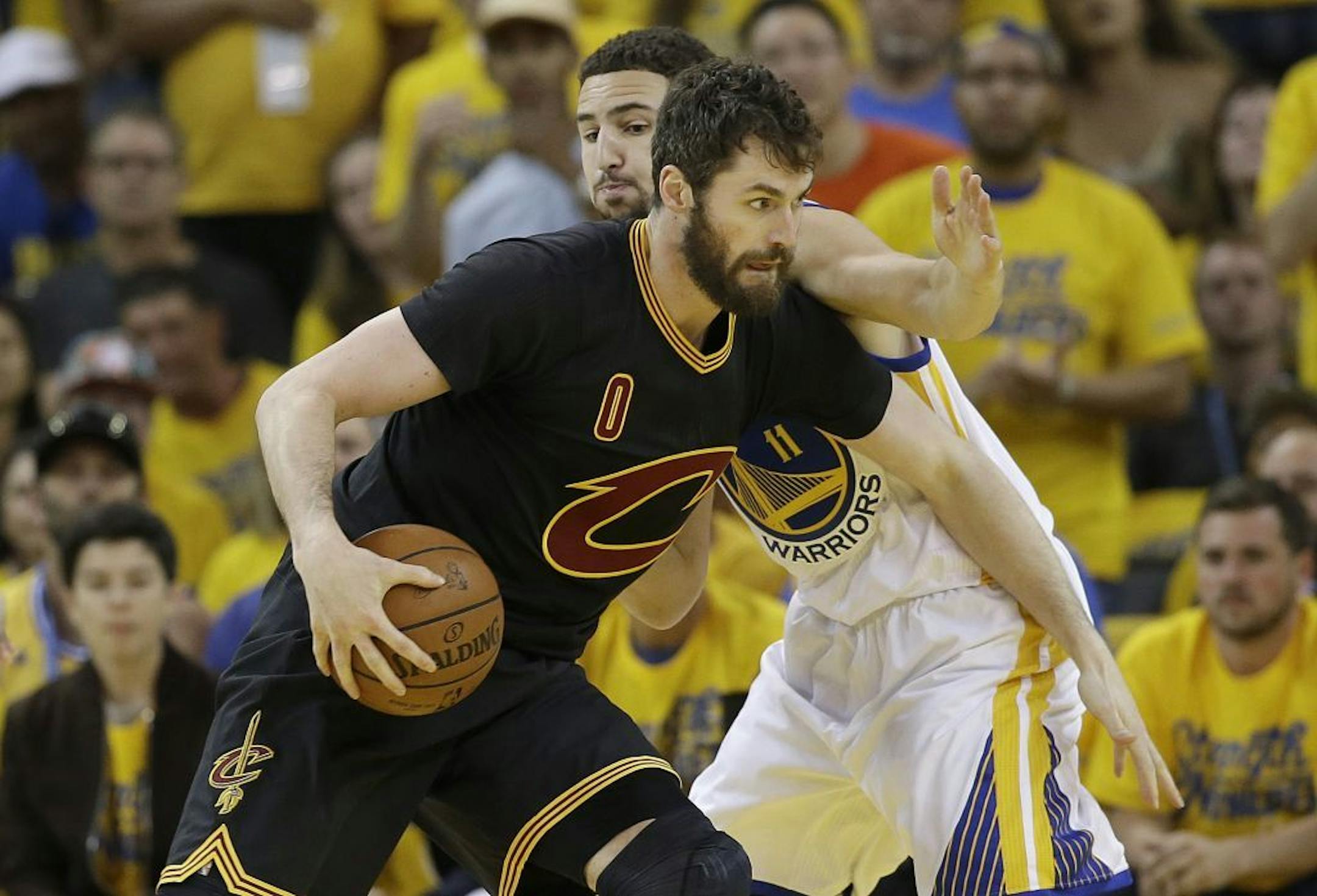 Cleveland Cavaliers forward Kevin Love (0) is defended by Golden State Warriors guard Klay Thompson (11) during the first half of Game 7 of basketball's NBA Finals in Oakland, Calif., Sunday, June 19, 2016.
