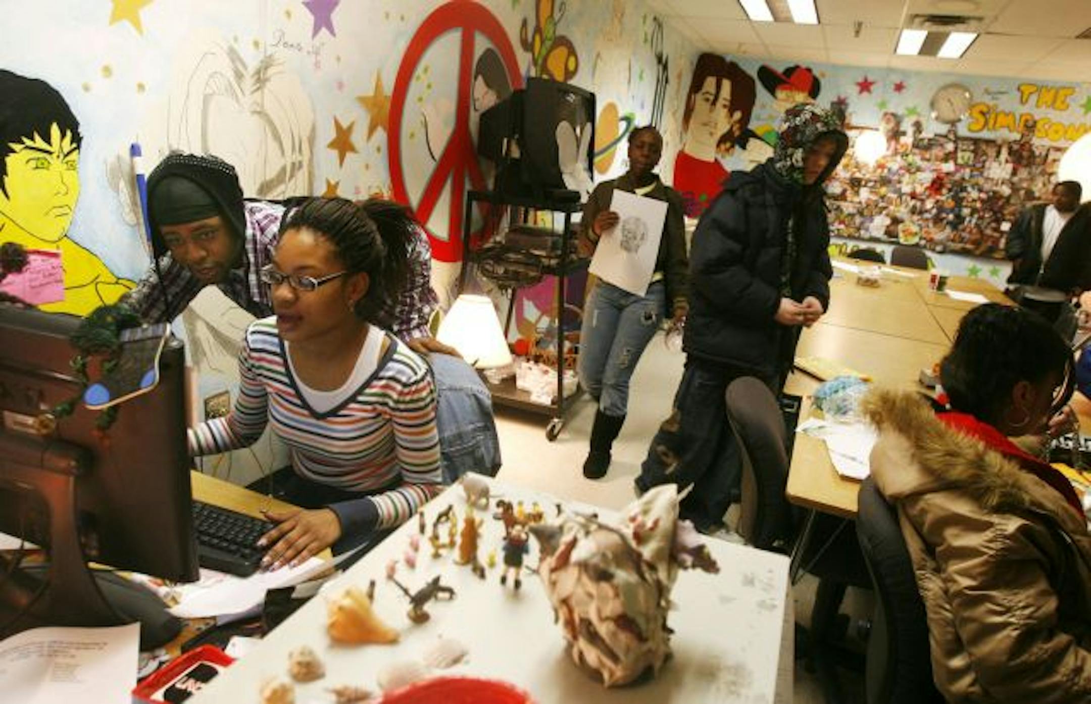 Community Alternative Learning Center senior Ebony Eaton, seated, types up a paper on jazz singer Billy Holiday while getting some editing assistance from fellow student Darwin Wiley. The St. Paul School District is shutting down the school at year's end as part of a district-wide initiative to save money but many are upset about the decision. "My teachers and principal have been my backbone," Eaton said. She said staff at the school care about her and fellow students personal and academic probl
