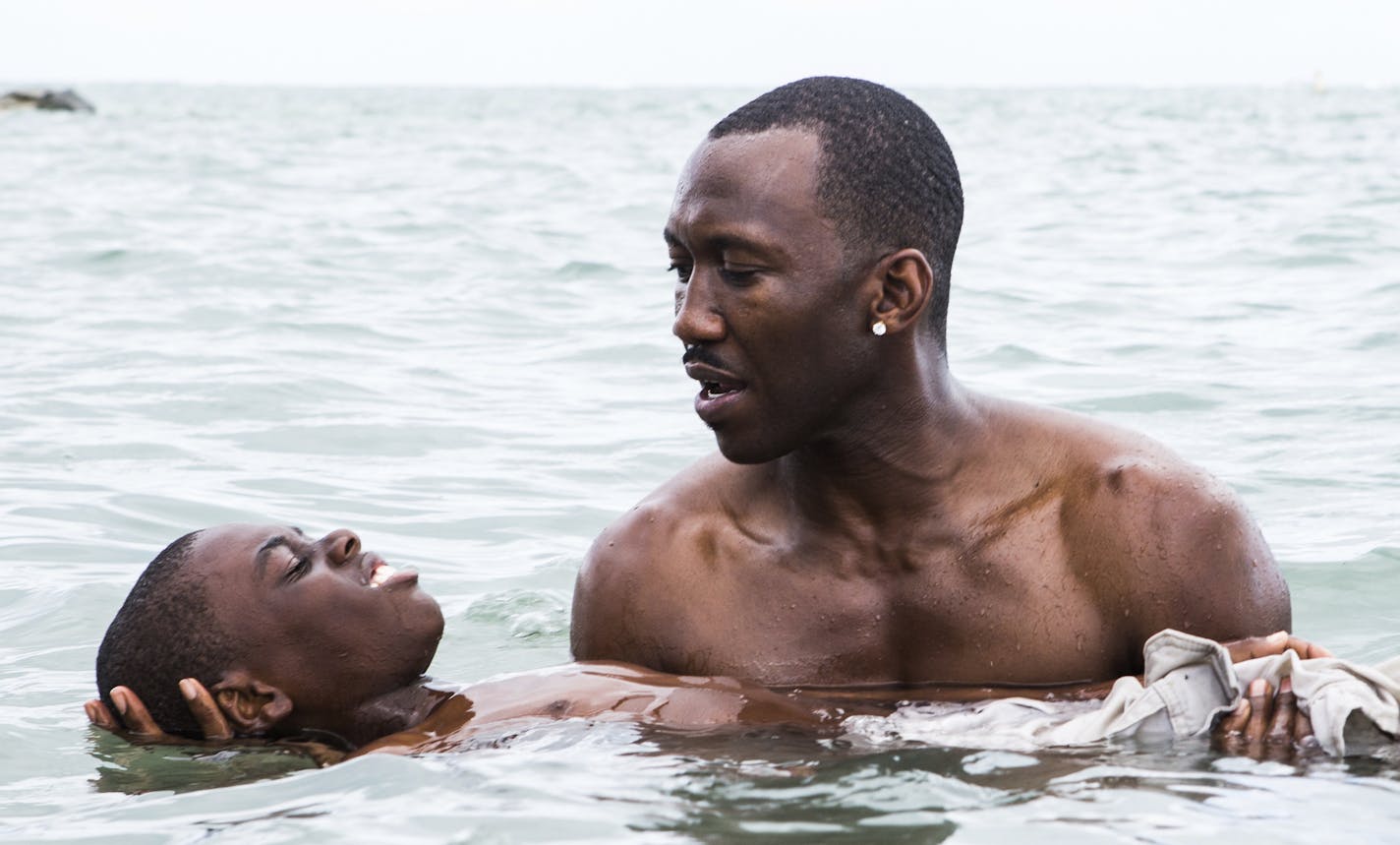 This image released by A24 shows Alex Hibbert, foreground, and Mahershala Ali in a scene from the film, "Moonlight." The Producers Guild of America has nominated awards season favorites &#xec;La La Land,&#xee; &#xec;Moonlight&#xee; and &#xec;Manchester by the Sea&#xee; for its top award, as well as the R-rated superhero film &#xec;Deadpool.&#xee; Winners will be announced in a Jan. 28 ceremony in Beverly Hills, Calif. (David Bornfriend/A24 via AP)