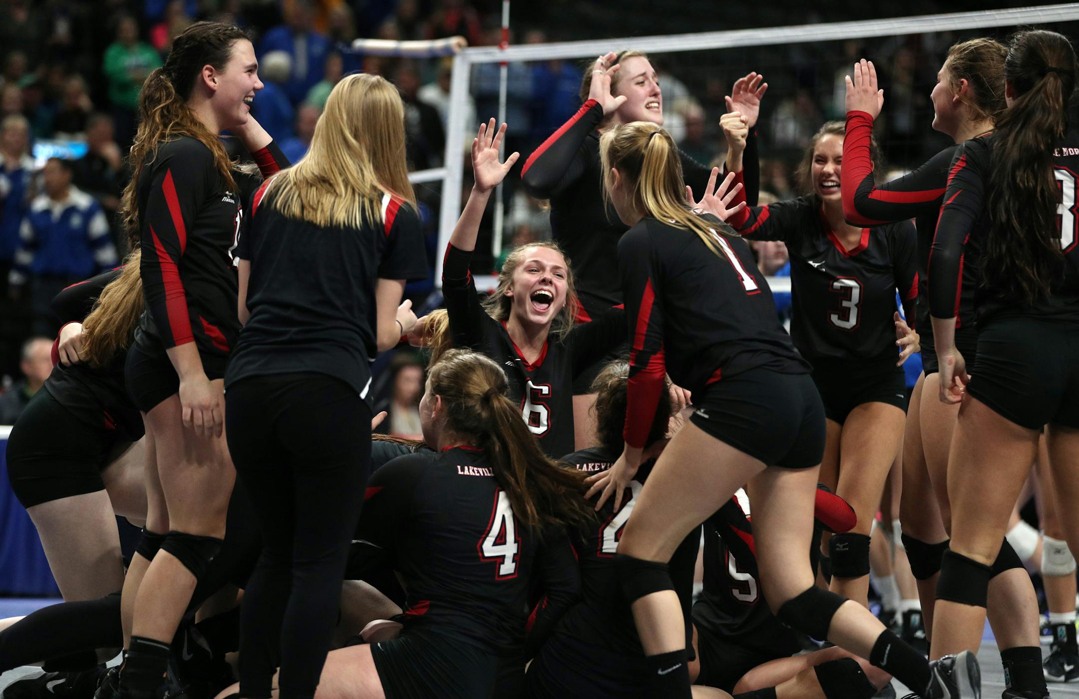 Lakeville North High School players celebrated on the court after defeating Eagan High School in the championship match. ] ANTHONY SOUFFLE ï anthony.souffle@startribune.com Game action from a Class 3A championship volleyball game between Eagan High School and Lakeville North High School Saturday, Nov. 11, 2017 at the Xcel Energy Center in St. Paul, Minn.