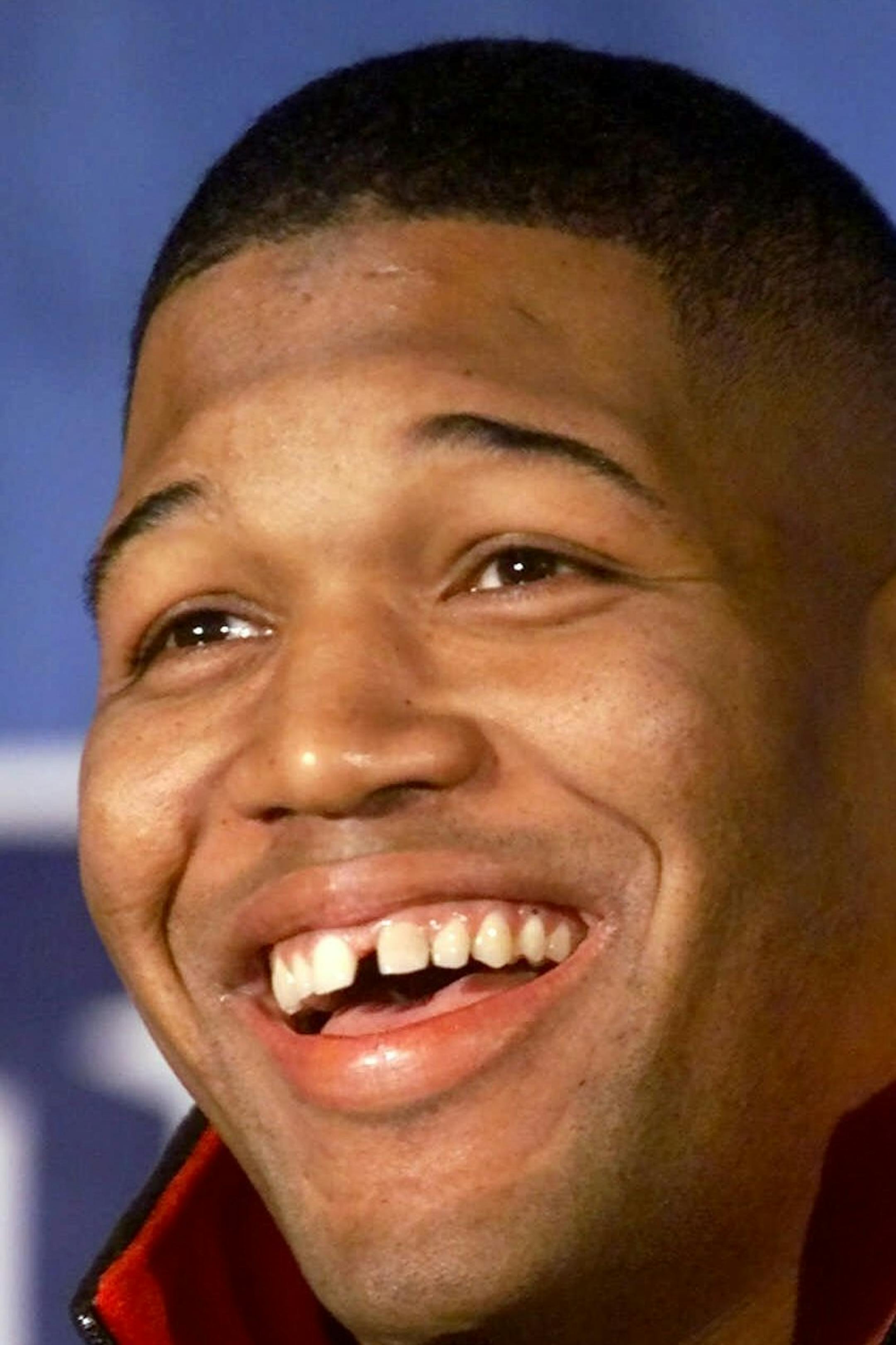 New York Giants defensive end Michael Strahan laughs during a news conference at New York's Inter-Continental Hotel Friday, Jan. 12, 2001. The Giants will face the Minnesota Vikings Sunday, Jan. 14, in the NFC Championship. (AP Photo/Mark Lennihan) ORG XMIT: NYR114
