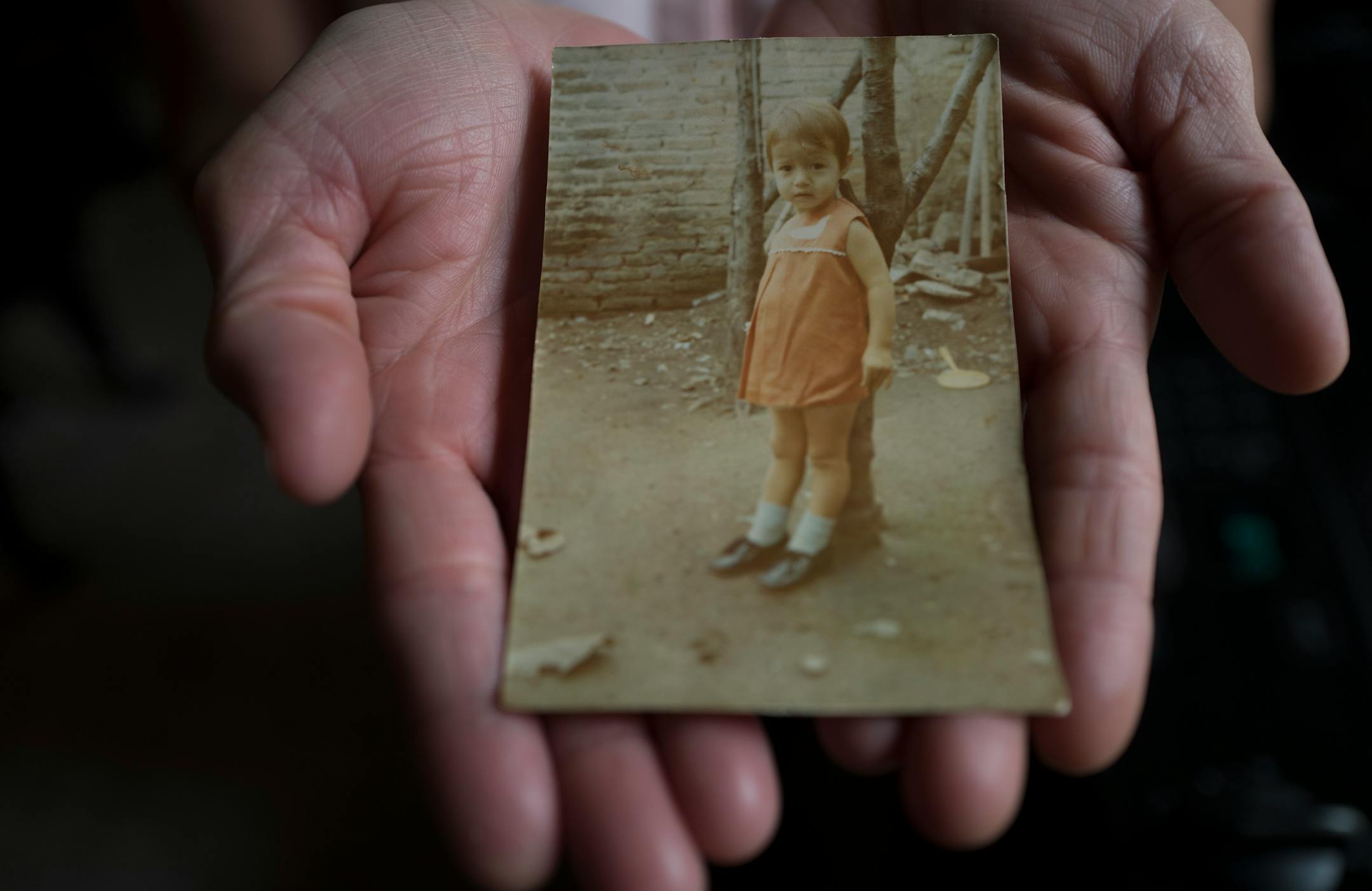 Gloria Velazquez was able to the stay in the United States legally after she received a U visa, for victims of serious crimes who cooperate with police. She is a live-in housekeeper for a family in St. Paul. In this photo she held a portrait of herself when she was a child in Mexico.