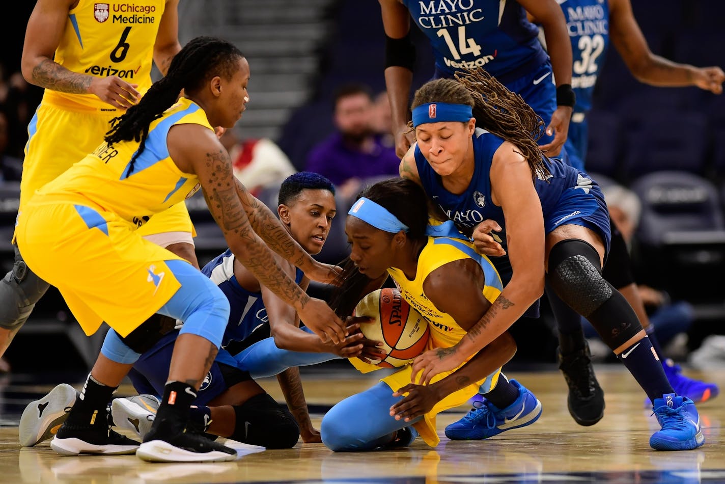 Minnesota Lynx guard Seimone Augustus (33) and guard Danielle Robinson (3) battled for a loose ball against Chicago Sky guard Kahleah Copper (2), bottom center, in the second quarter.