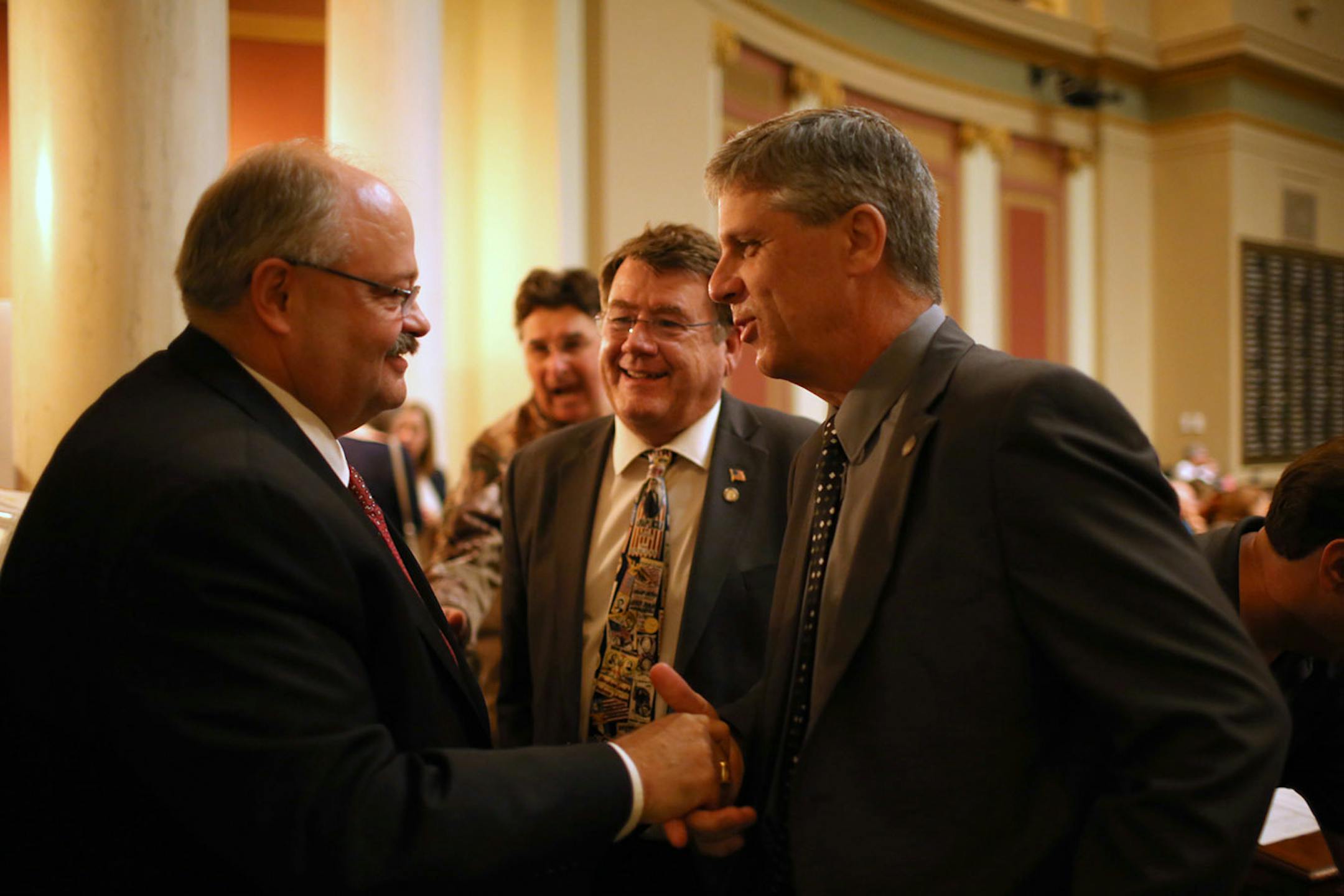 State representative Greg Davids, R-Preston, left, was congratulated on the passage of H.F. 848 by colleagues Jerry Hertaus, R-Greenfield and Steve Drazkowski, R-Mazeppa. After speaking in support of the bill, it passed 122-10 Sunday afternoon. ] JEFF WHEELER ï jeff.wheeler@startribune Legislators worked Sunday to agree on spending, tax cuts, and borrowing ahead of their midnightt adjournment deadline Sunday, May 22, 2016.