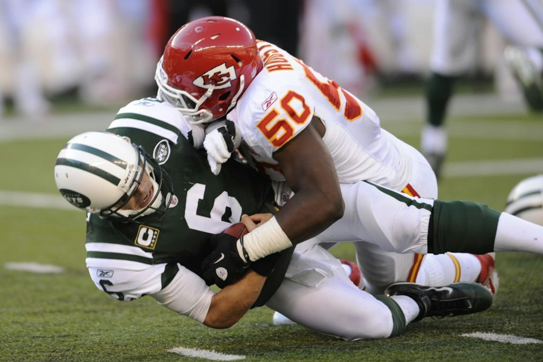 New York Jets' quarterback Mark Sanchez is sacked by Kansas City Chiefs' Justin Houston during the second quarter of their NFL football game, Sunday, Dec. 11, 2011, in East Rutherford, N.J.