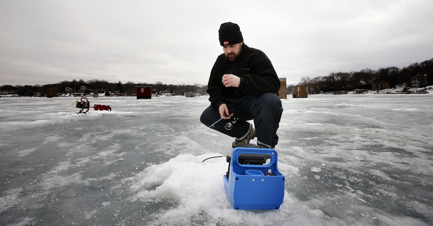 Jim Elliason, 37 of Prior Lake ice fishing at Upper Prior Lake on Tuesday afternoon. ] CARLOS GONZALEZ cgonzalez@startribune.com, January 27, 2015, Prior Lake, Minn., Outdoors Weekend story is about south metro and south-state ice fishing