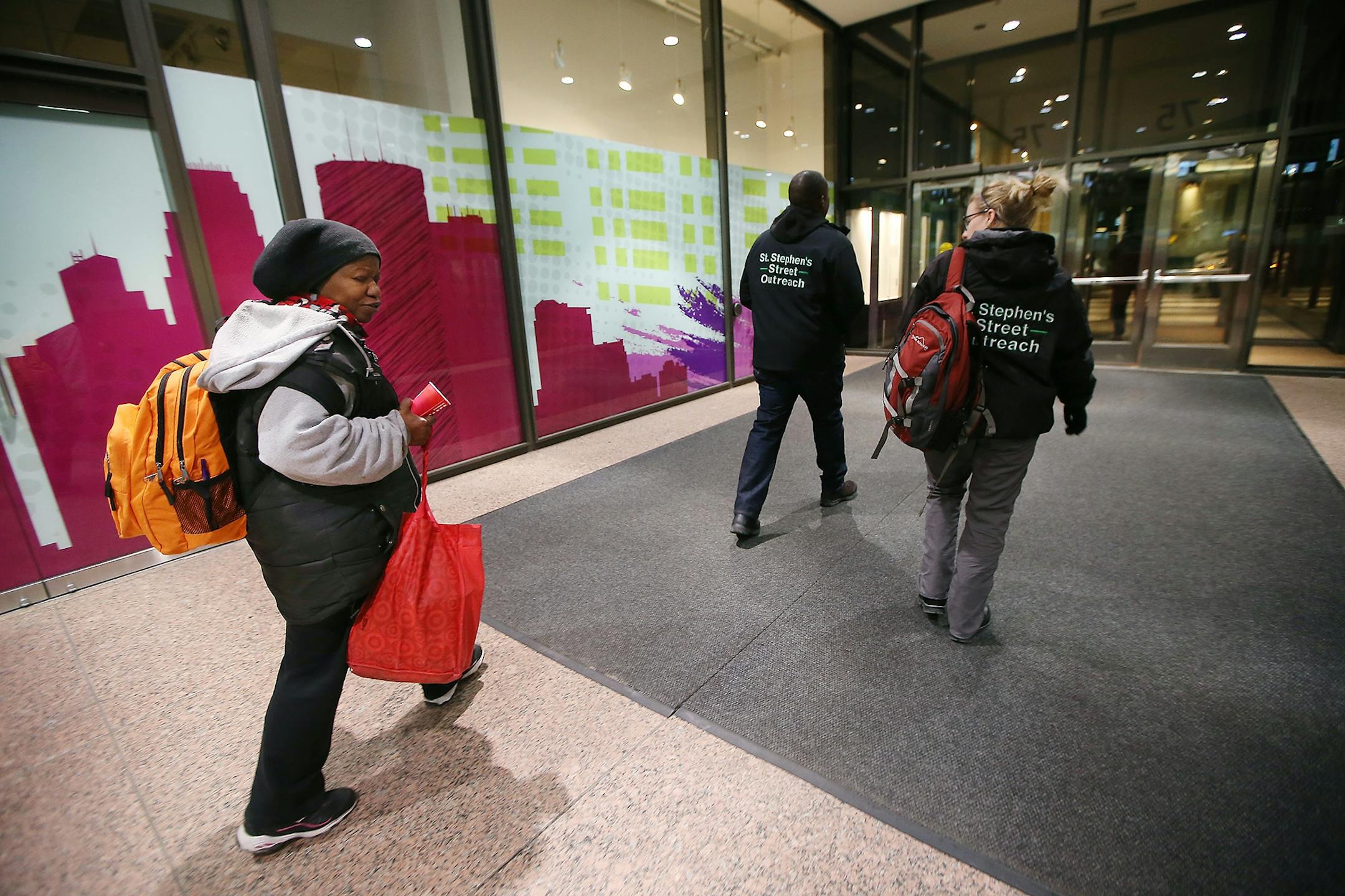 David Jeffries, Director of Single Adult Programs, left, and Breanna Schell, MSW, LGSW, and the Street Outreach Program Manager St. Stephen's Human Services, led Donna to their car to give her socks and other items after she spent the night on the rail system early Thursday, January 28, 2015 in Minneapolis, MN.