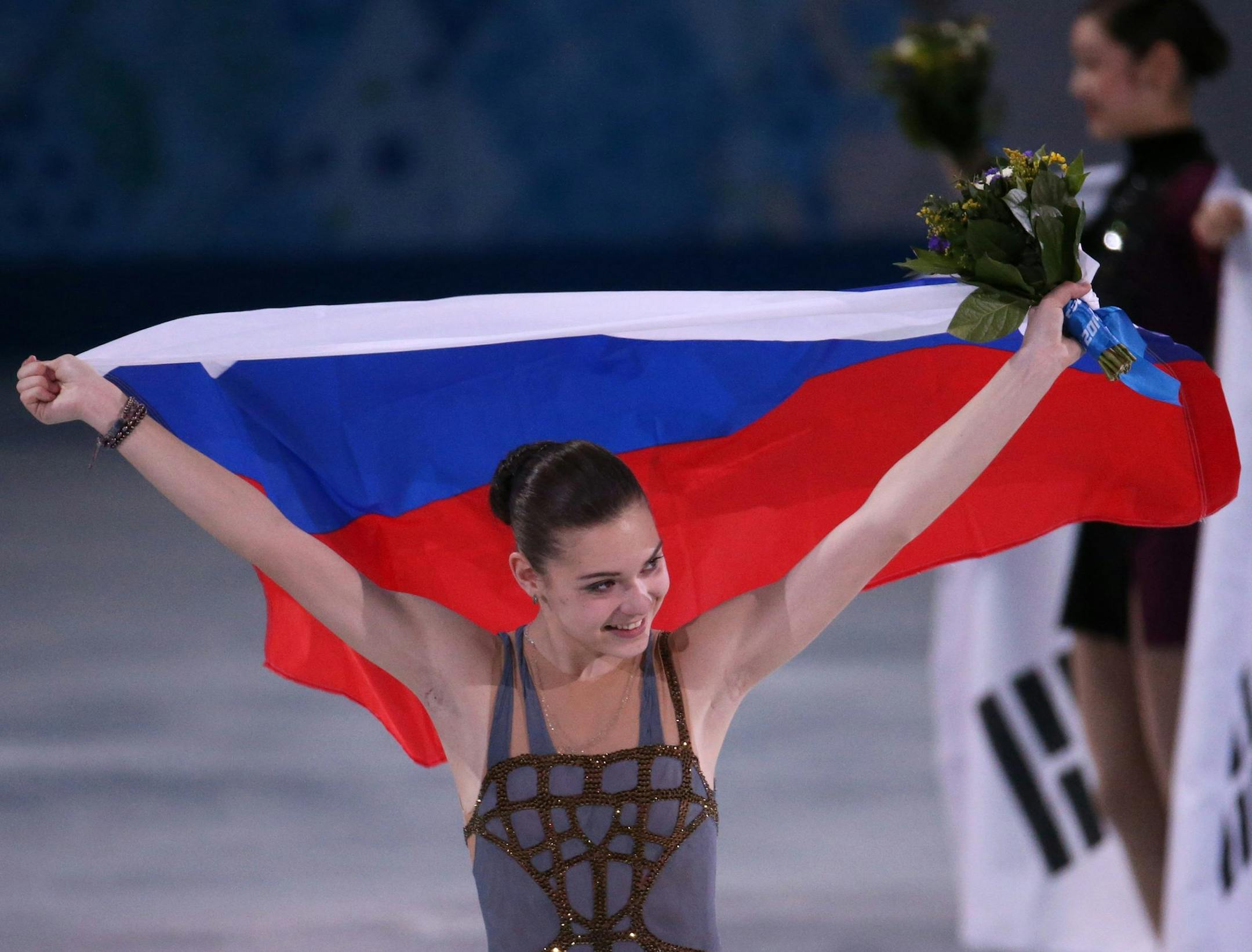 Adelina Sotnikova of Russia celebrates her gold medal in ladies' figure skating at the Iceberg Skating Palace during the Winter Olympics in Sochi, Russia, Thursday, Feb. 20, 2014. Behind her Yuna Kim of South Korea celebrates her silver medal. (Brian Cassella/Chicago Tribune/MCT) ORG XMIT: 1149421 ORG XMIT: MIN1402201404333428
