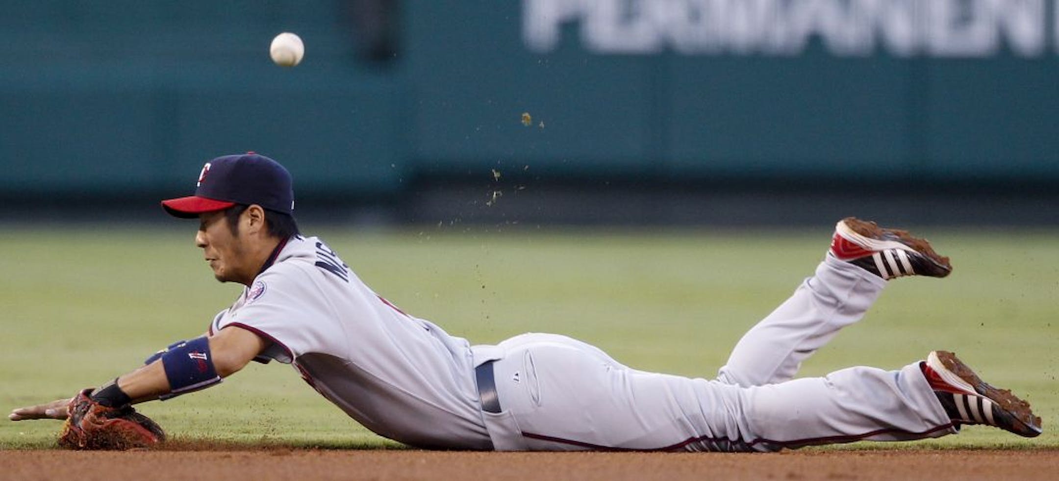 Minnesota shortstop Tsuyoshi Nishioka can't get a glove on a base hit by Los Angeles' Torii Hunter.