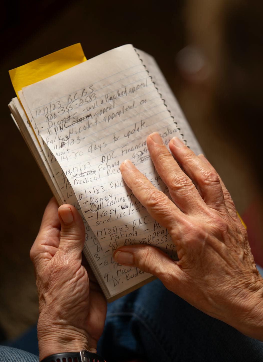 Christine Knirk, with the notebook she has kept while battling for insurance coverage, photographed in her Burnsville home on April 8. At issue is a sinus surgery performed in March 2023 that produced a good medical outcome, Knirk says, but her health insurer later said was not medically necessary.