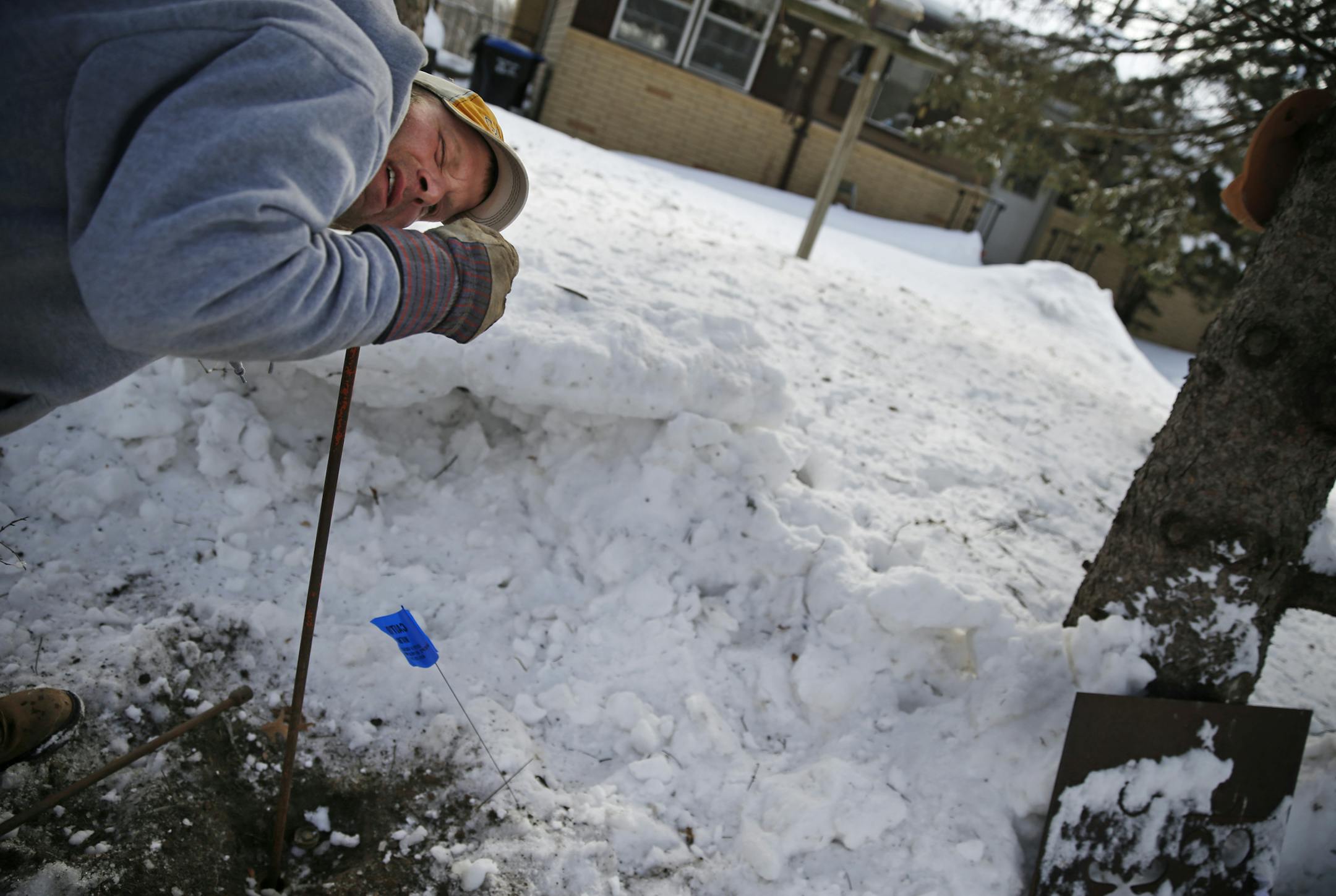 On the 400 block of Glenwood Ave. in Roseville, utilities worker Jason Hill listened to the sounds coming up from the street shutoff valve to see if the ice was being cleared in the water pipe from the house to the main.]richard tsong-taatarii/rtsong-taatarii@startribune.com
