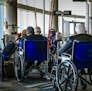 Houston, TX, USA - December 5, 2012: Handicapped travelers in wheelchairs wait in line to a the gate to board their plane at Houston Int. airport in T