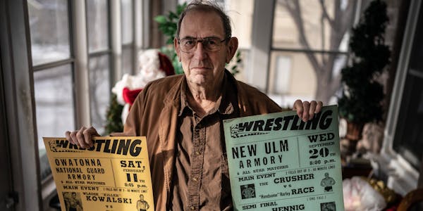 Norm Kietzer with wrestling promotional posters he created.