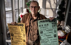 Norm Kietzer with wrestling promotional posters he created.