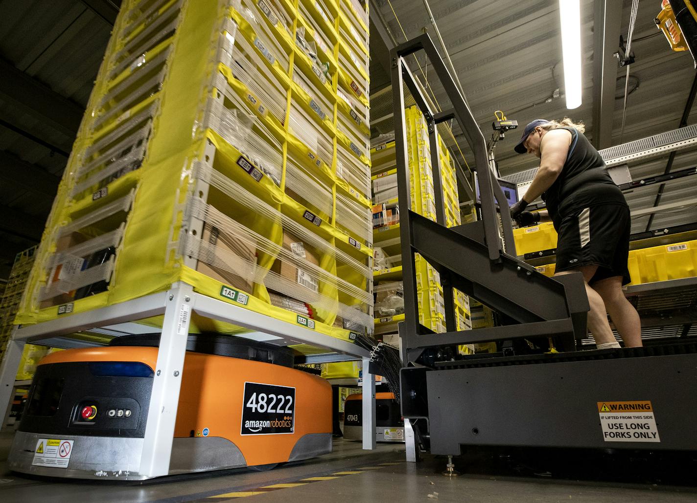 Amazon Robotic drives fit under pods filled with various items and move them around the Amazon fulfillment center in Shakopee. ] CARLOS GONZALEZ &#x2022; cgonzalez@startribune.com &#x2013; Shakopee, MN &#x2013; May 8, 2019, Tour Amazon fulfillment center in Shakopee