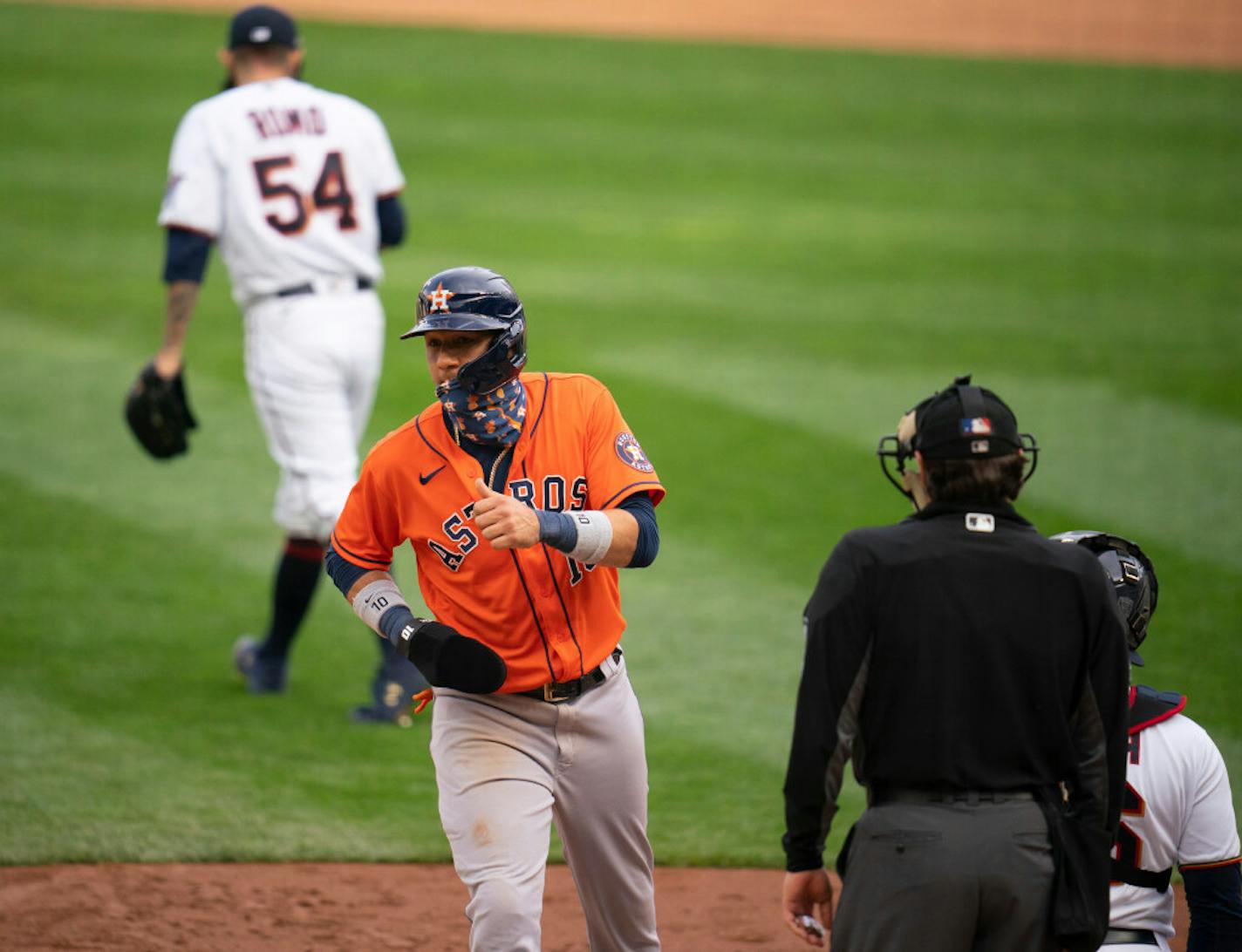 The Astros Yuli Gurriel scored after Minnesota Twins relief pitcher Sergio Romo (54), rear, walked Houston Astros second baseman Jose Altuve (27) with the bases loaded in the ninth inning.