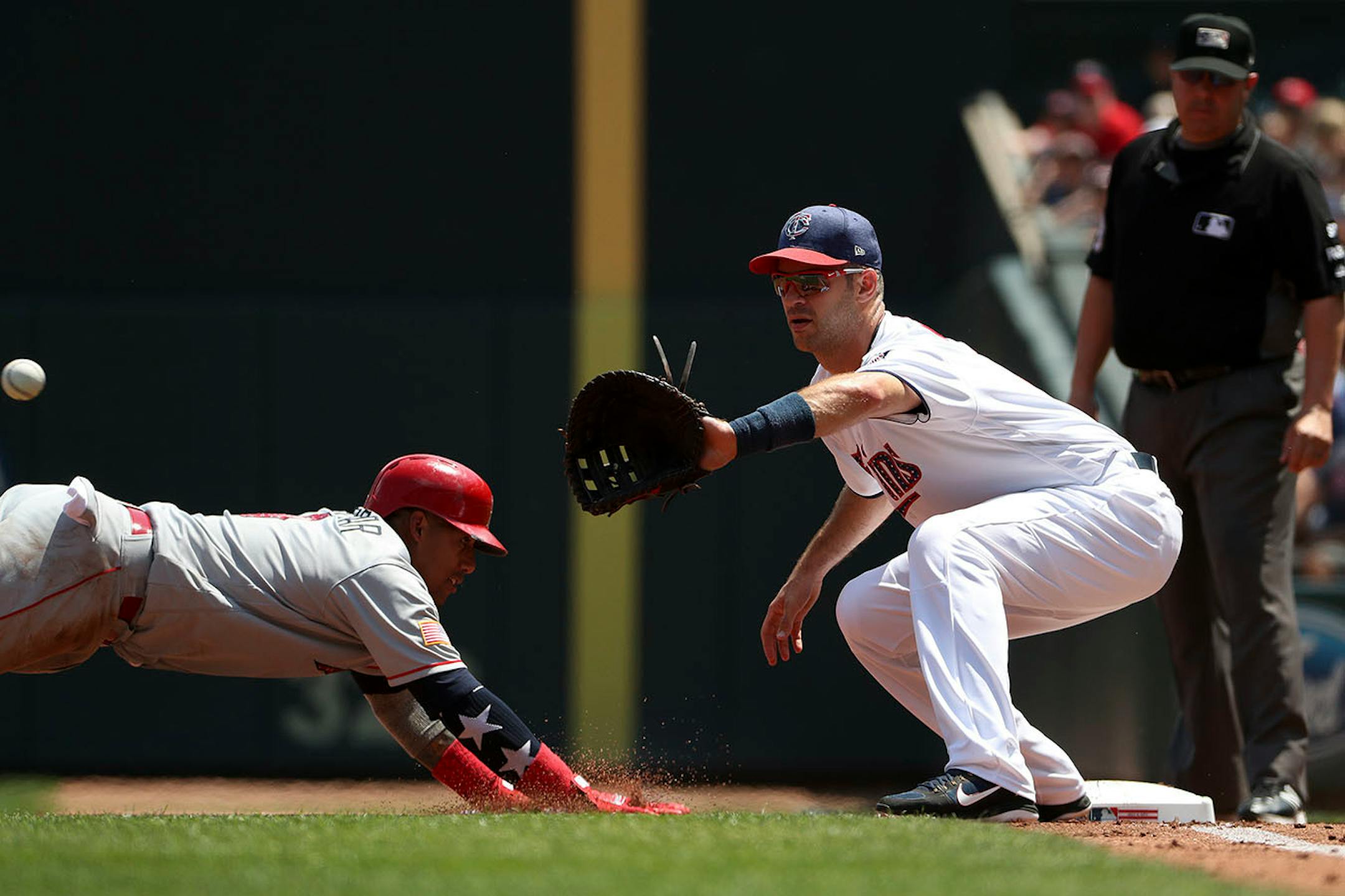 Minnesota Twins first baseman Joe Mauer (7) looked to tag out Los Angeles Angels third baseman Yunel Escobar (0) at first base on a throw from Minnesota Twins starting pitcher Kyle Gibson (44) in the second inning.