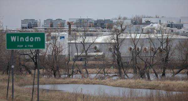 The HyLife Foods pork processing plant looms in the back ground on the outskirts of Windom, Minn.