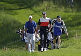 Tiger Woods, left, and Brooks Koepka walk to the 14th fairway during the first round of the PGA Championship golf tournament, Thursday, May 16, 2019, 