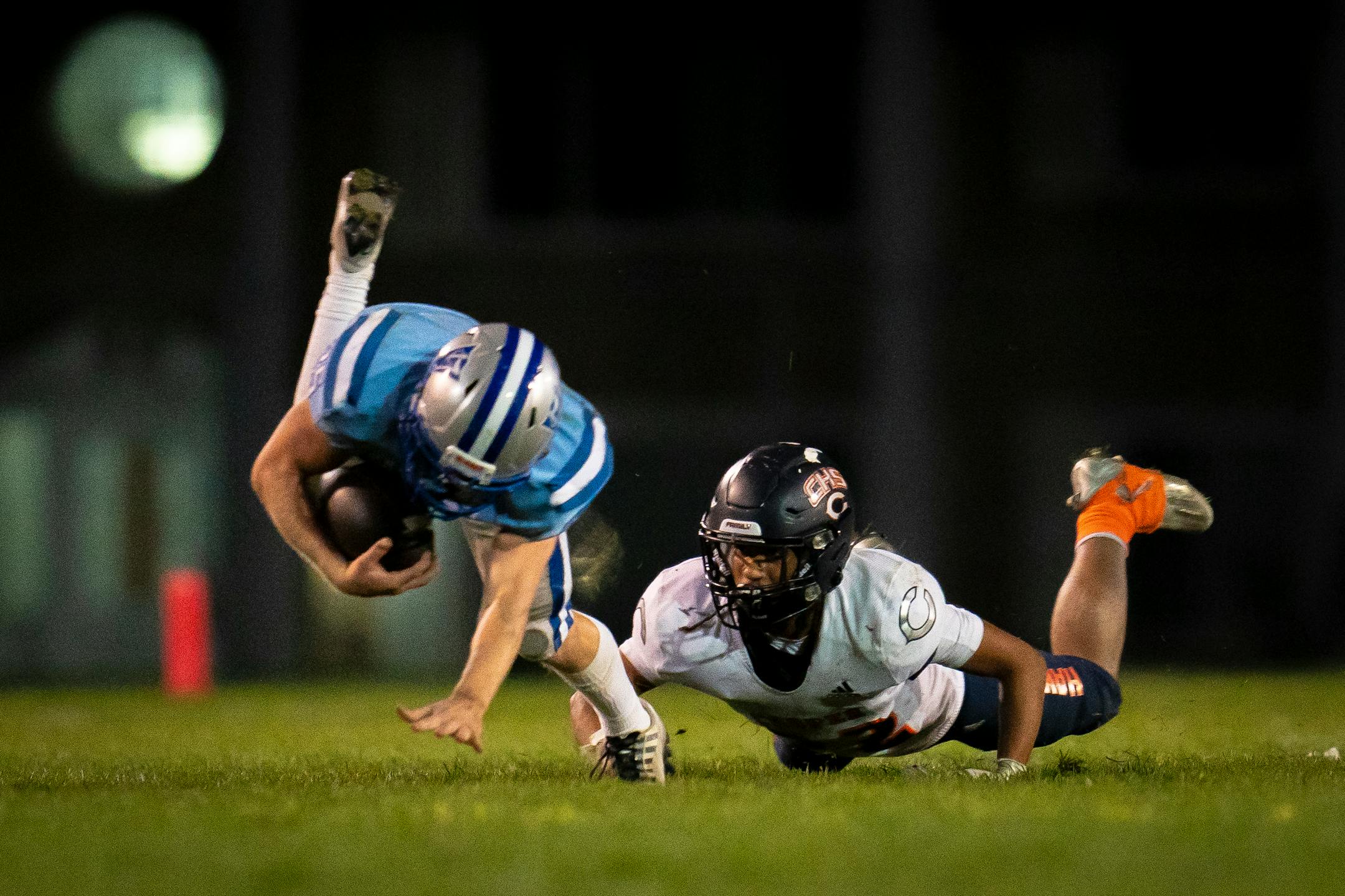 Robbinsdale Cooper's Ray Heiland (22) attempts to tackle Bloomington Jefferson's Jonathan Weber (25) Friday night.