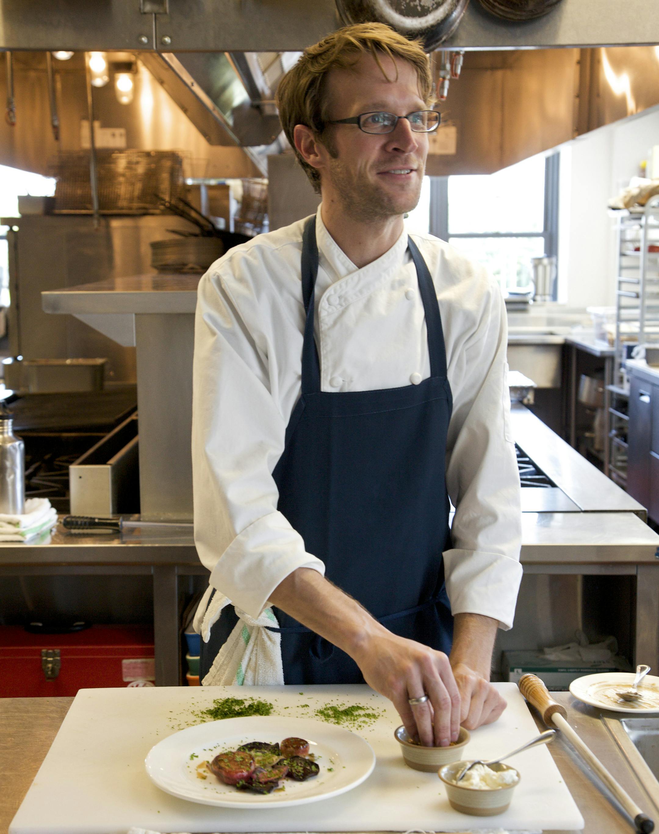 Paul Berglund, a chef at the Bachelor Farmer, a restaurant that blends Scandinavian design, prepares a dish at the restaurant in Minneapolis, July 23, 2012. Cooks in the Twin Cities are suddenly embracing Nordic heritage based on cold-weather crops, traditional foodways and naturalistic presentations. (Allen Brisson-Smith/The New York Times) ORG XMIT: MIN2013032813312394
