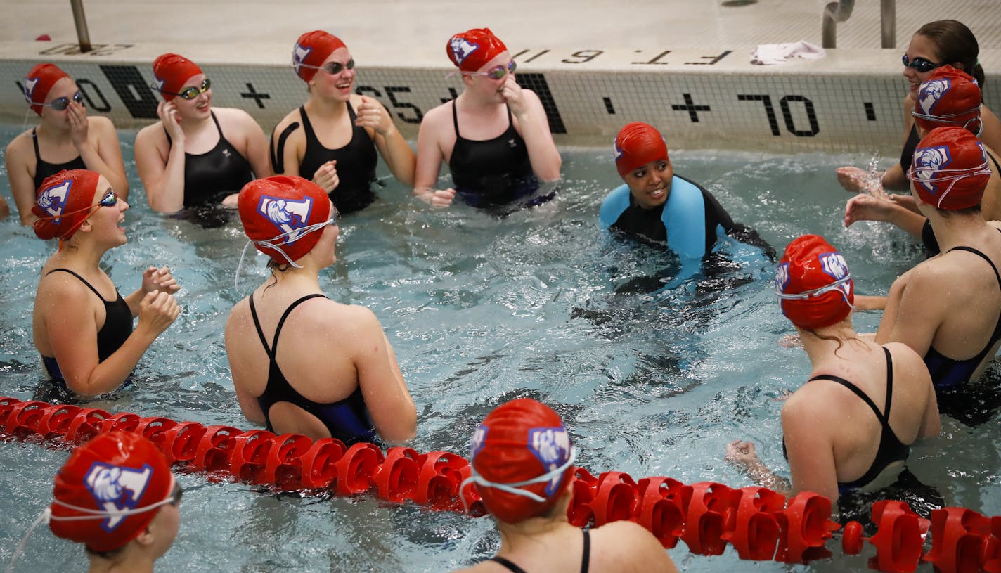 Suhan Mohamed, in swimsuit with blue arms, did a cheer in the water with her fellow teammates before a swim meet at Apollo High School in St. Cloud, Minn., on Thursday, October 5, 2017. Nimo Gohe (not pictured) and Suhan Mohamed just learned to swim this summer and are now on the Apollo High School swim team.] RENEE JONES SCHNEIDER &#x2022; renee.jones@startribune.com