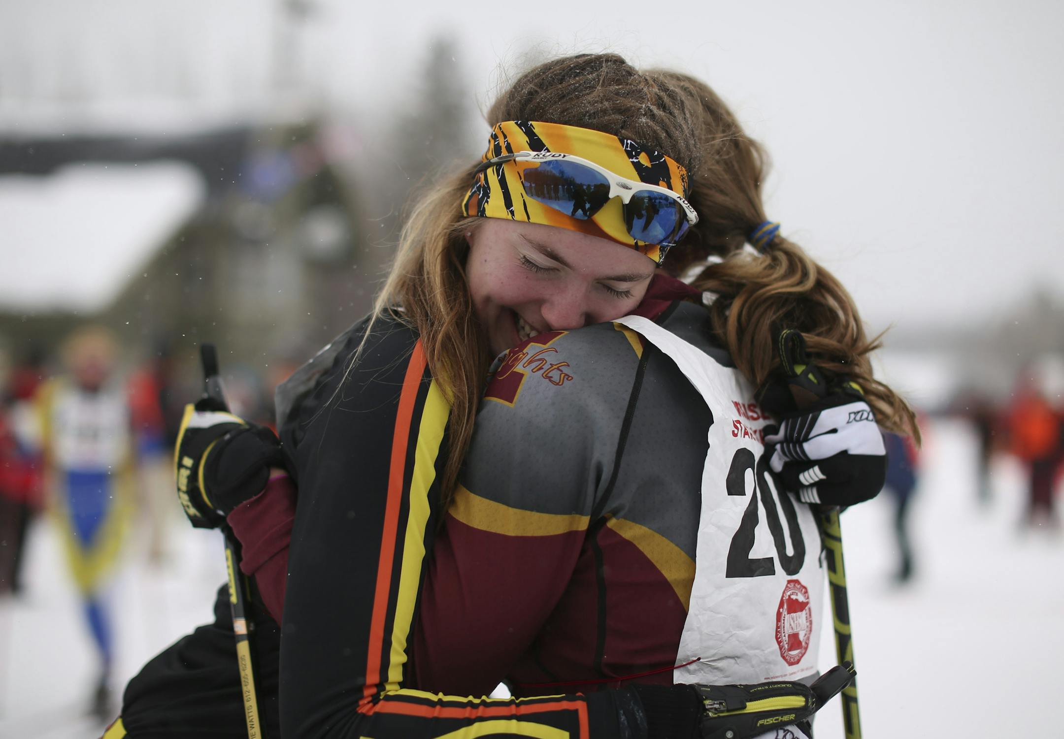 Burnsville's Vivian Hett, left, ils hugged by Irondale's Mattie Watts after they finished the 5-kilometer classical race just second apart at the state Nordic ski meet Thursday, Feb. 13, 2014, in Biwabik, Minn. Watts won, and Hett was second. (AP Photo/Star Tribune, Jeff Wheeler) MINNEAPOLIS-AREA TV OUT MAGS OUT ST. PAUL OUT