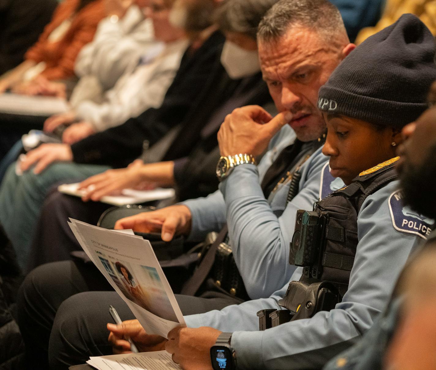 Minneapolis Police Chief Brian O'Hara and officer Yolanda Wilks listen to community presentations by three firms vying to become Minneapolis' new independent evaluator at a meeting at Plymouth Congregational Church on Wednesday, Jan. 10, 2023. Wilks is the commander of the Implementation Agreement.