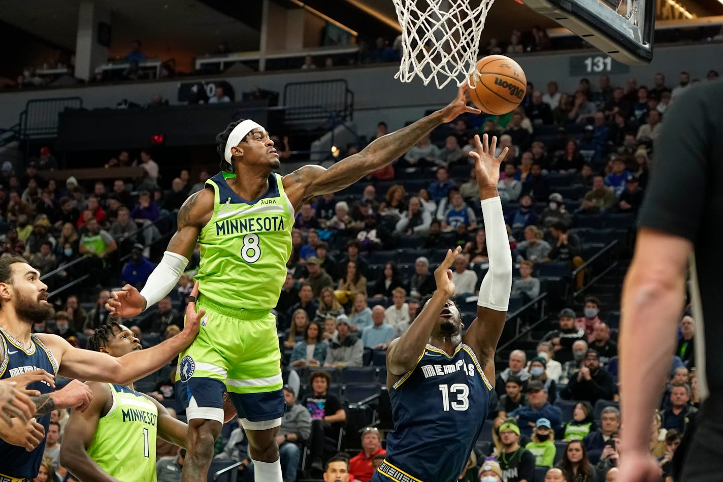 Minnesota Timberwolves forward Jarred Vanderbilt (8) blocks a shot by Memphis Grizzlies forward Jaren Jackson Jr. (13) during the first half of an NBA basketball game Saturday, Nov. 20, 2021, in Minneapolis. (AP Photo/Craig Lassig)