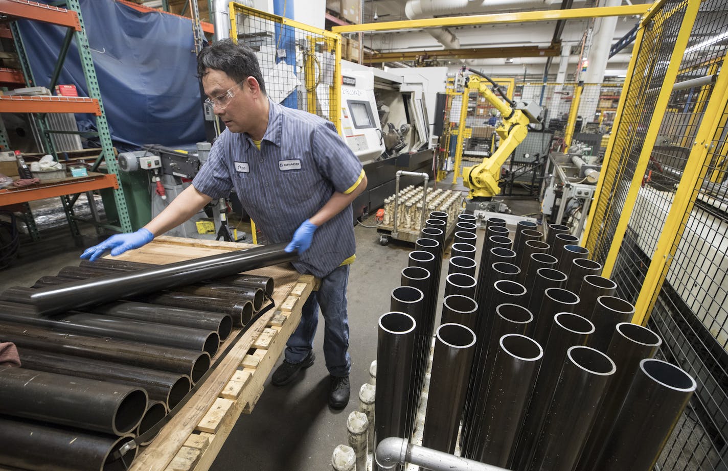 Thao Nguyen (cq) an employee at Graco, and stacked tubes of carbon steel Monday March 12, 2018 in Minneapolis, MN.] JERRY HOLT &#x2022; jerry.holt@startribune.com