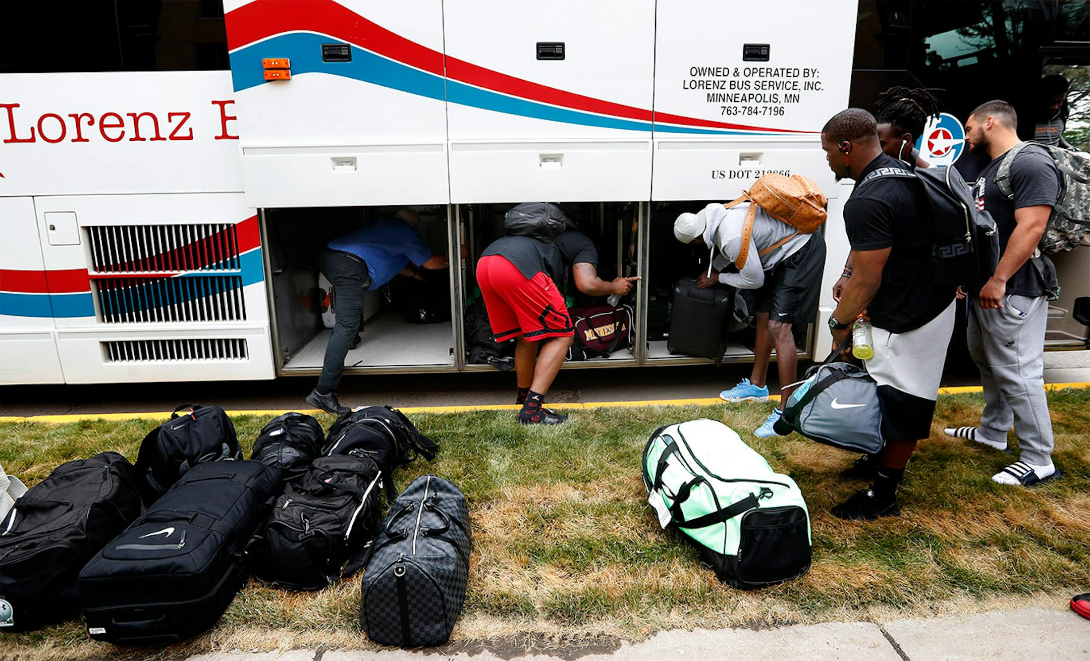 Players unloaded their gear from a bus after arrive in Mankato for Training Camp.