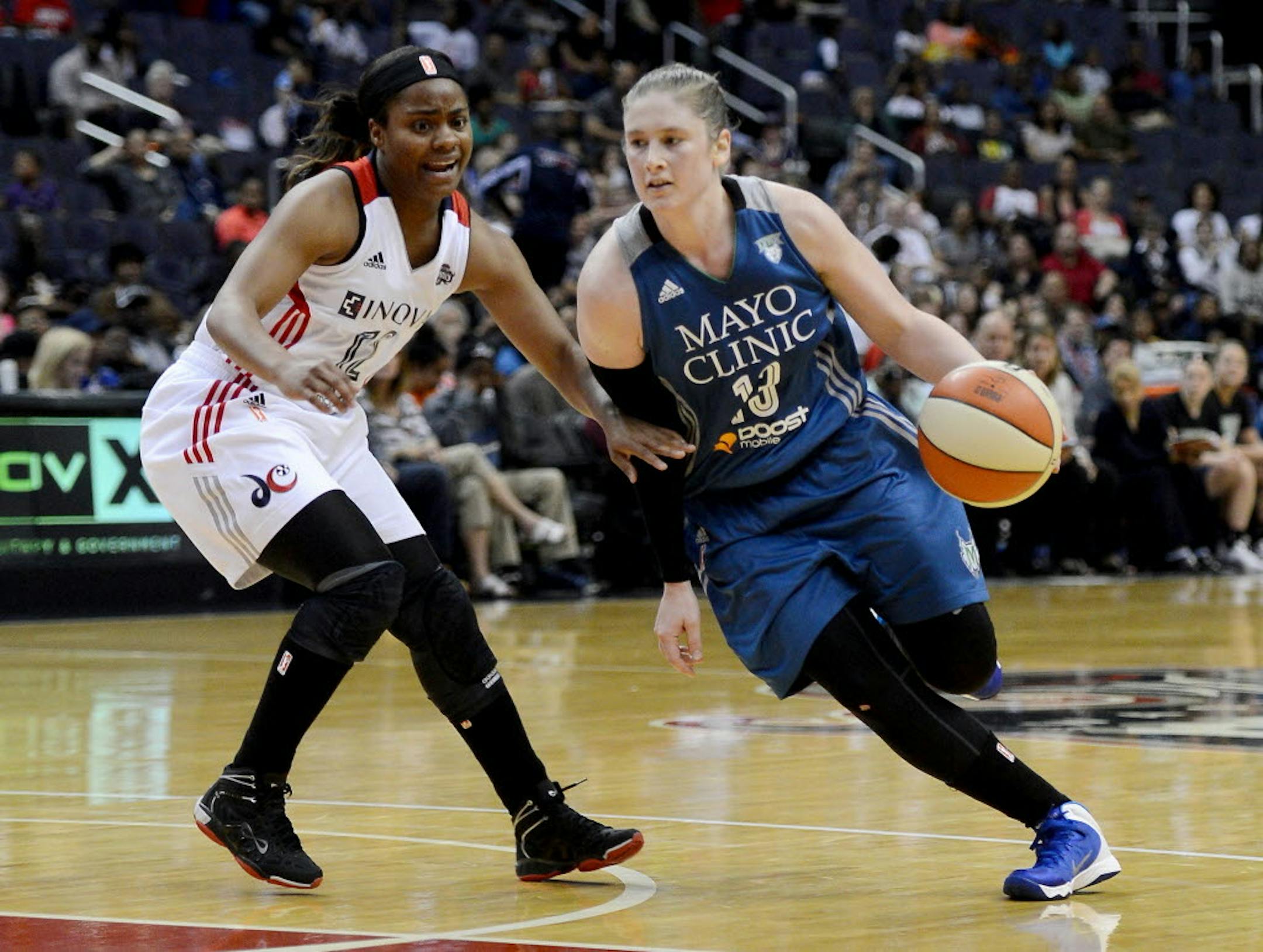Minnesota Lynx guard Lindsay Whalen (13) dribbles against Washington Mystics guard Ivory Latta (12) in the third quarter at the Verizon Center in Washington, D.C., Friday, May 16, 2014. The Lynx defeated the Mystics, 89-77