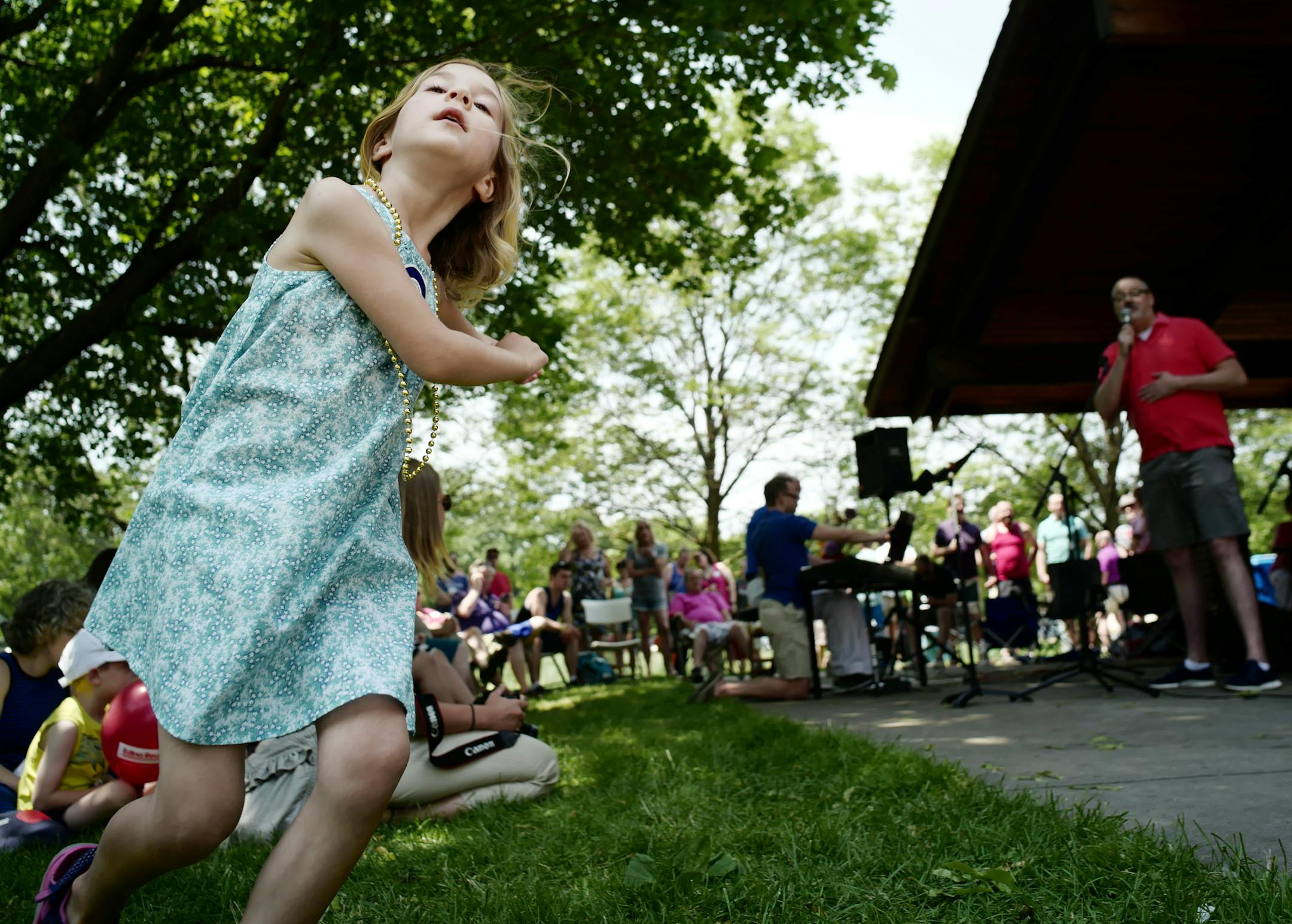 Zoey Shad, 5, danced her own interpretation of a tune while a member of the Twin Cities Gay Men's Chorus sang. Members of the LGBT community celebrated Pride weekend in Golden Valley on Sunday, but also remembered the tragedy in Orlando that took the lives of 50 people.