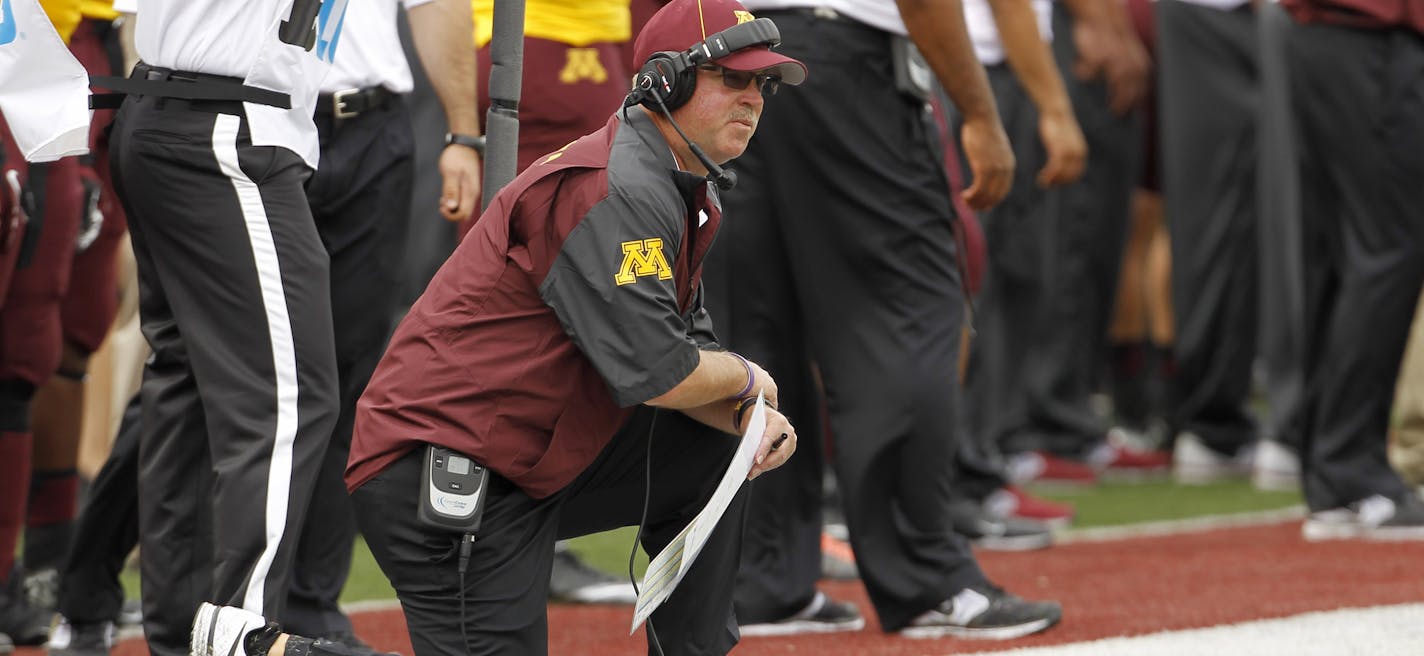 Minnesota head coach Jerry Kill kneels on the sidelines during the second quarter of an NCAA college football game against Western Illinois in Minneapolis, Saturday, Sept. 14, 2013. (AP Photo/Ann Heisenfelt)