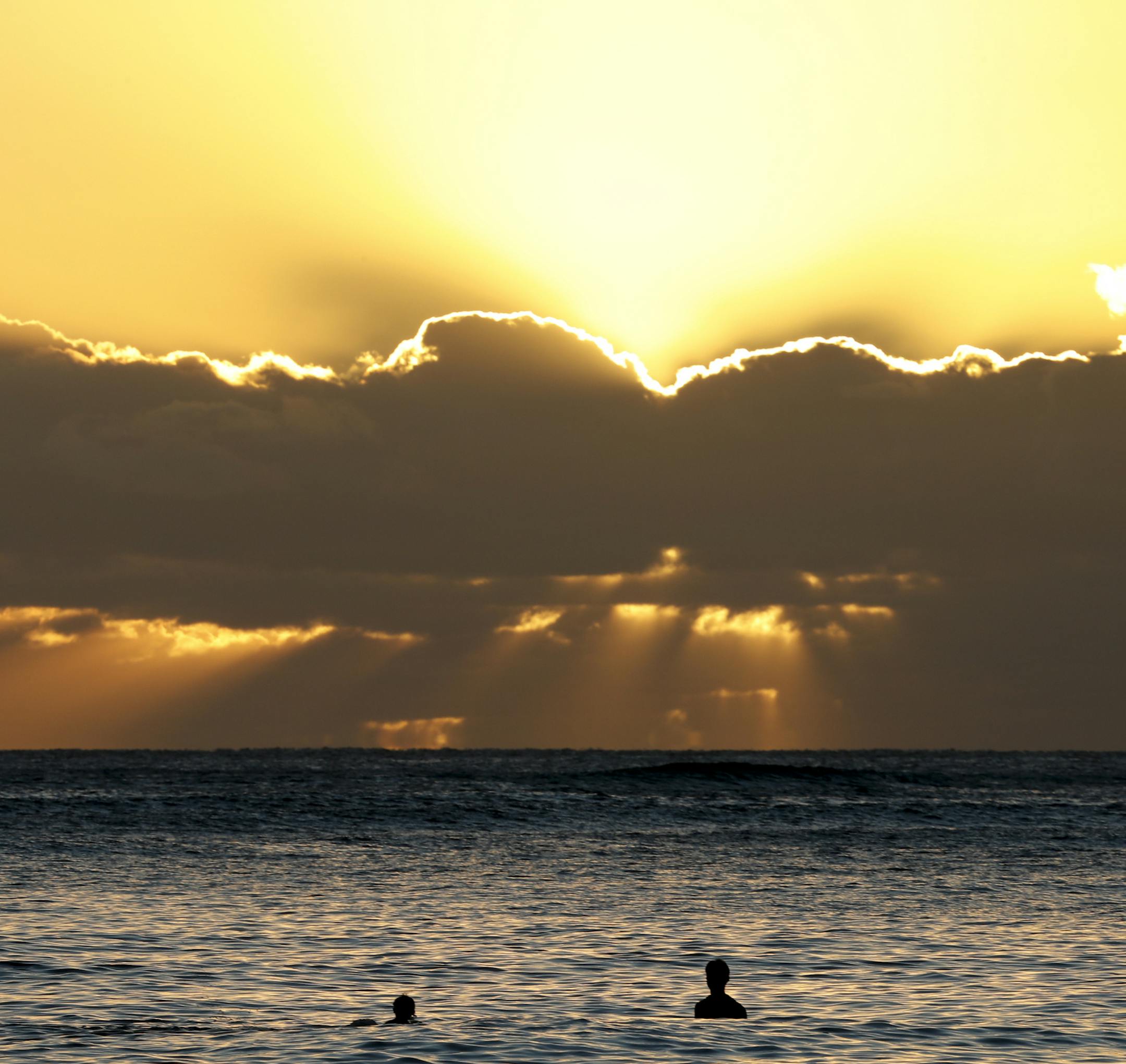 Swimmers watch the sun set in Honolulu. Hawaii hasn&#x2019;t had any locally acquired cases of Zika.