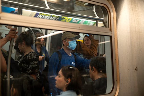 A masked rider on a subway train at Union Square in Manhattan, May 11, 2023.