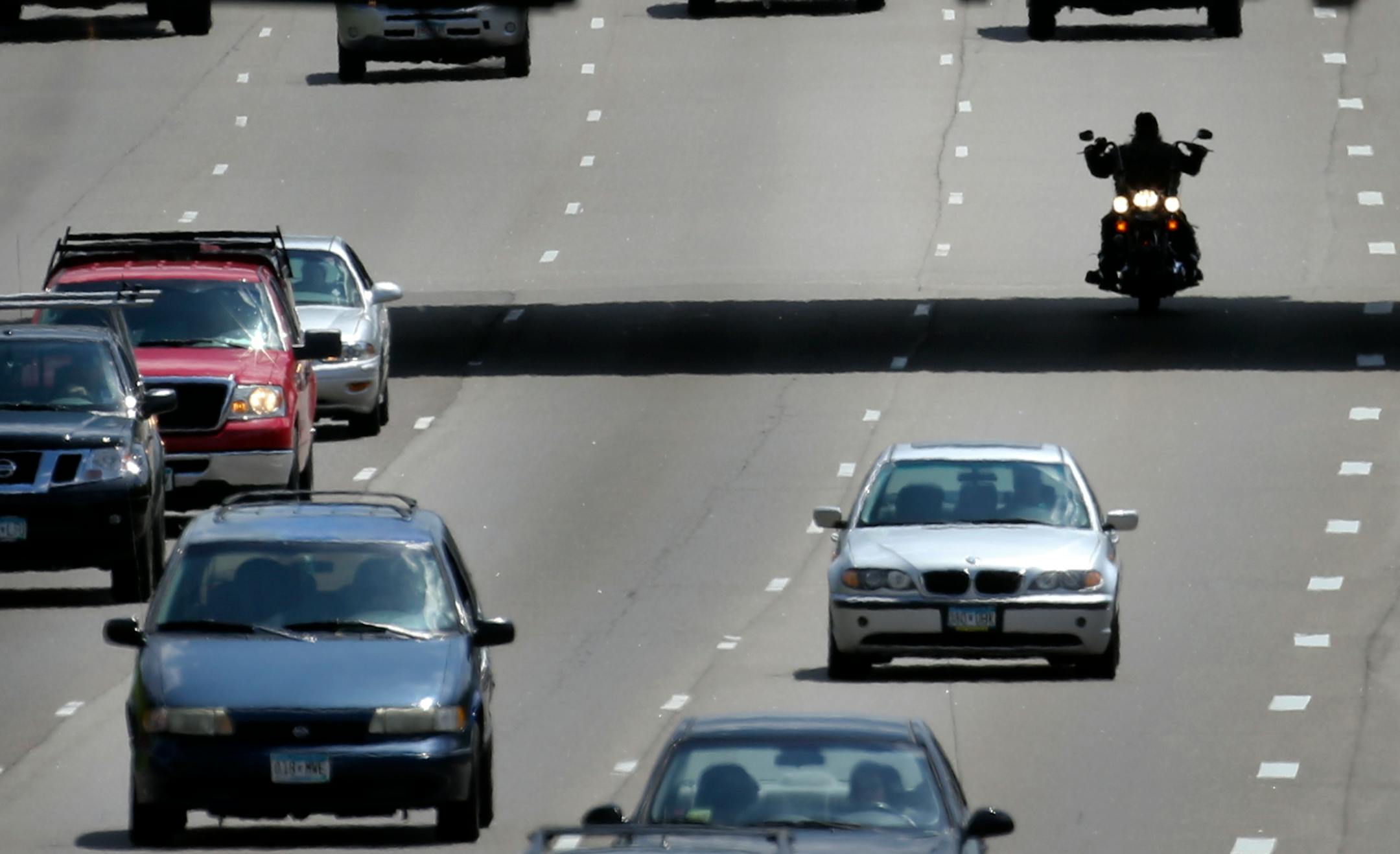 Seen from the 40th Street pedestrian bridge, a motorcylcist is sihlouetted beneath the 42nd Street Bridge while traveling north along I-35W, Friday, June 6, 2014, just south of downtown Minneapolis.