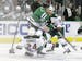 Wild defenseman Matt Dumba was knocked off his feet by Stars center Mattias Janmark as others looked for a route into the action during the first peri