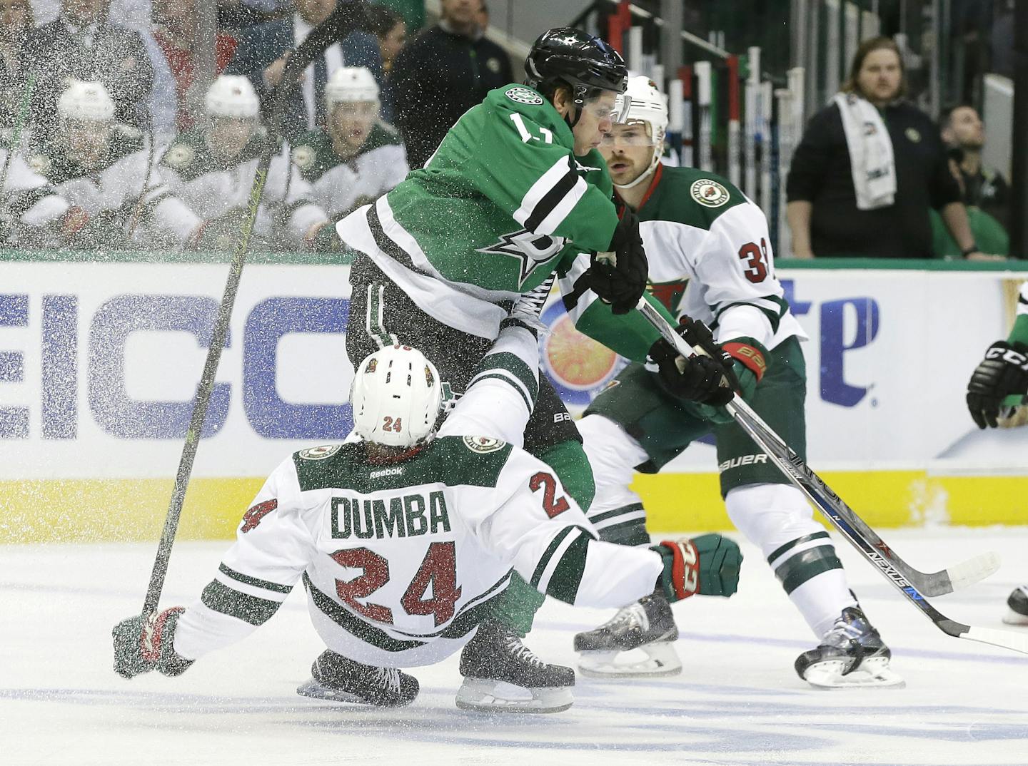 Wild defenseman Matt Dumba was knocked off his feet by Stars center Mattias Janmark as others looked for a route into the action during the first period of Game 1 Thursday.