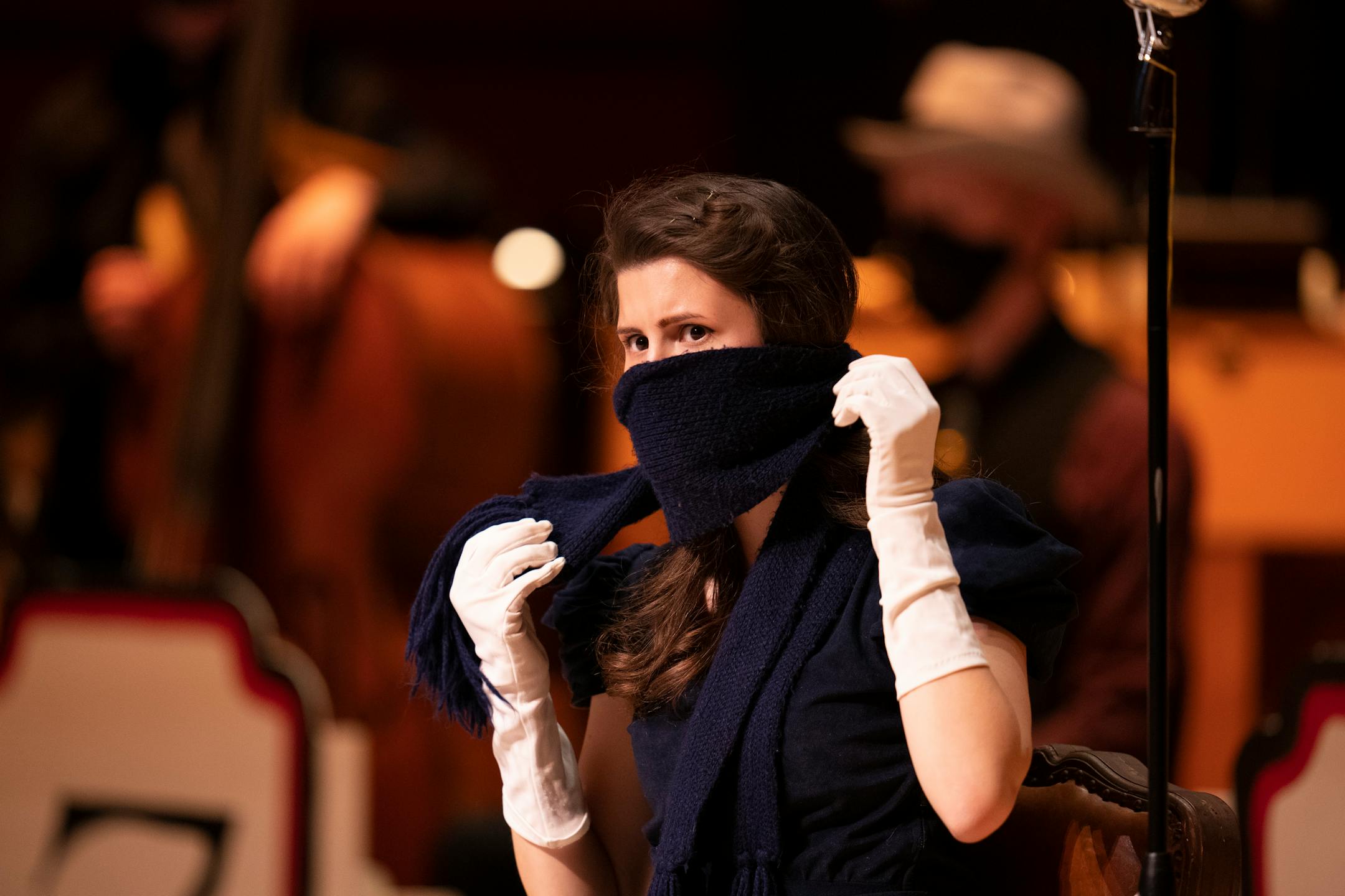 Alaina Sandau put her scarf back in place between dialogue segments of a scene in The 1940's Radio Hour.