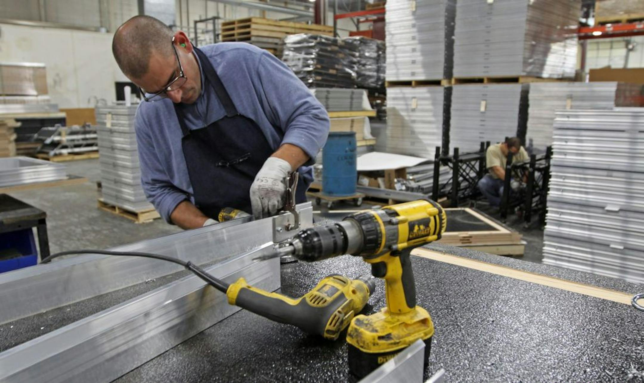 In this file photo from September 2011, Kirk Stewart of Staging Concepts in Brooklyn Park drilled the frame of a stage platform. The firm, a manufacturer of stages, platforms and risers, participated in ExporTech, a program helping them boost exports. Its customers include companies in Canada and Venezuela.