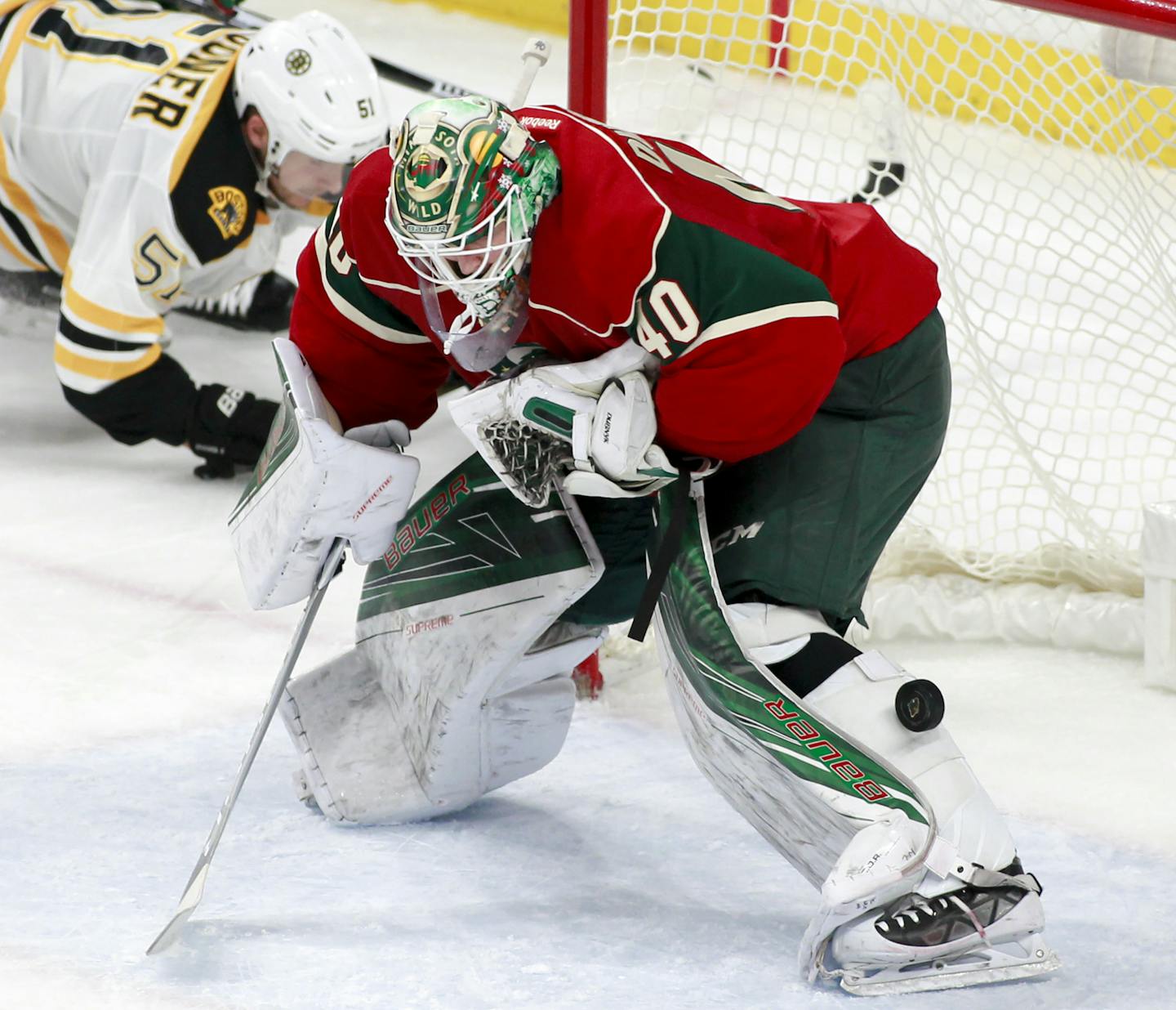 Minnesota Wild goalie Devan Dubnyk (40) has the puck roll down his leg as he makes a save during the third period of an NHL hockey game, Thursday, Nov. 17, 2016, in St. Paul, Minn. (AP Photo/Paul Battaglia)