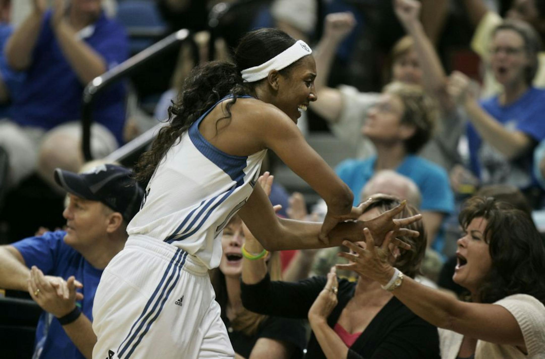 Lynx Candice Wiggins celebrated with crowd after her three point shot that forced a Seattle timeout in the first half at Target Center in Minneapolis , Minn., Friday, July 29, 2011.