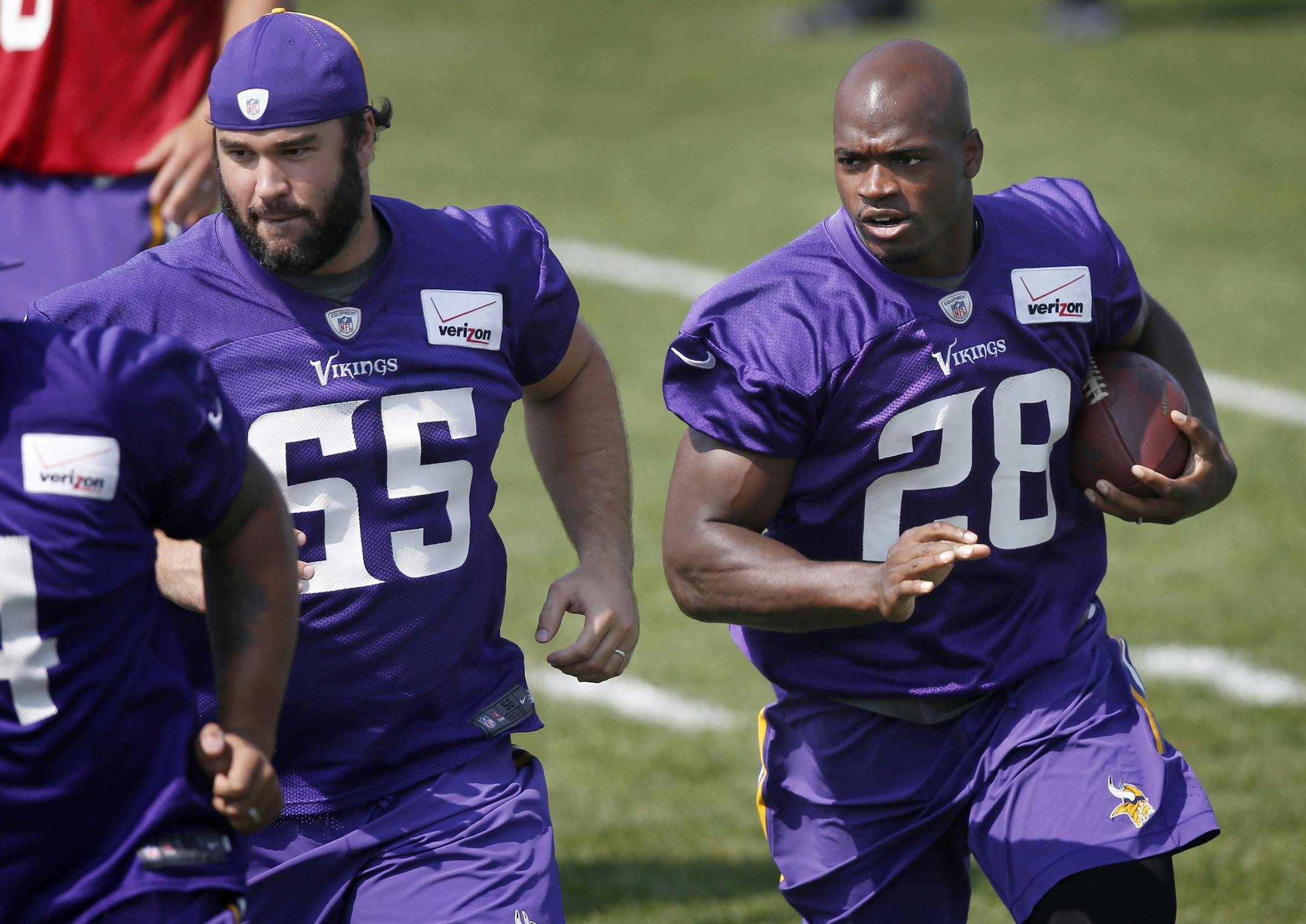 Veteran Vikings center John Sullivan (65), working out with Adrian Peterson during the Vikings morning practice on Saturday in Mankato, said that this year’s team is trying to follow the lead of its new coach, Mike Zimmer.