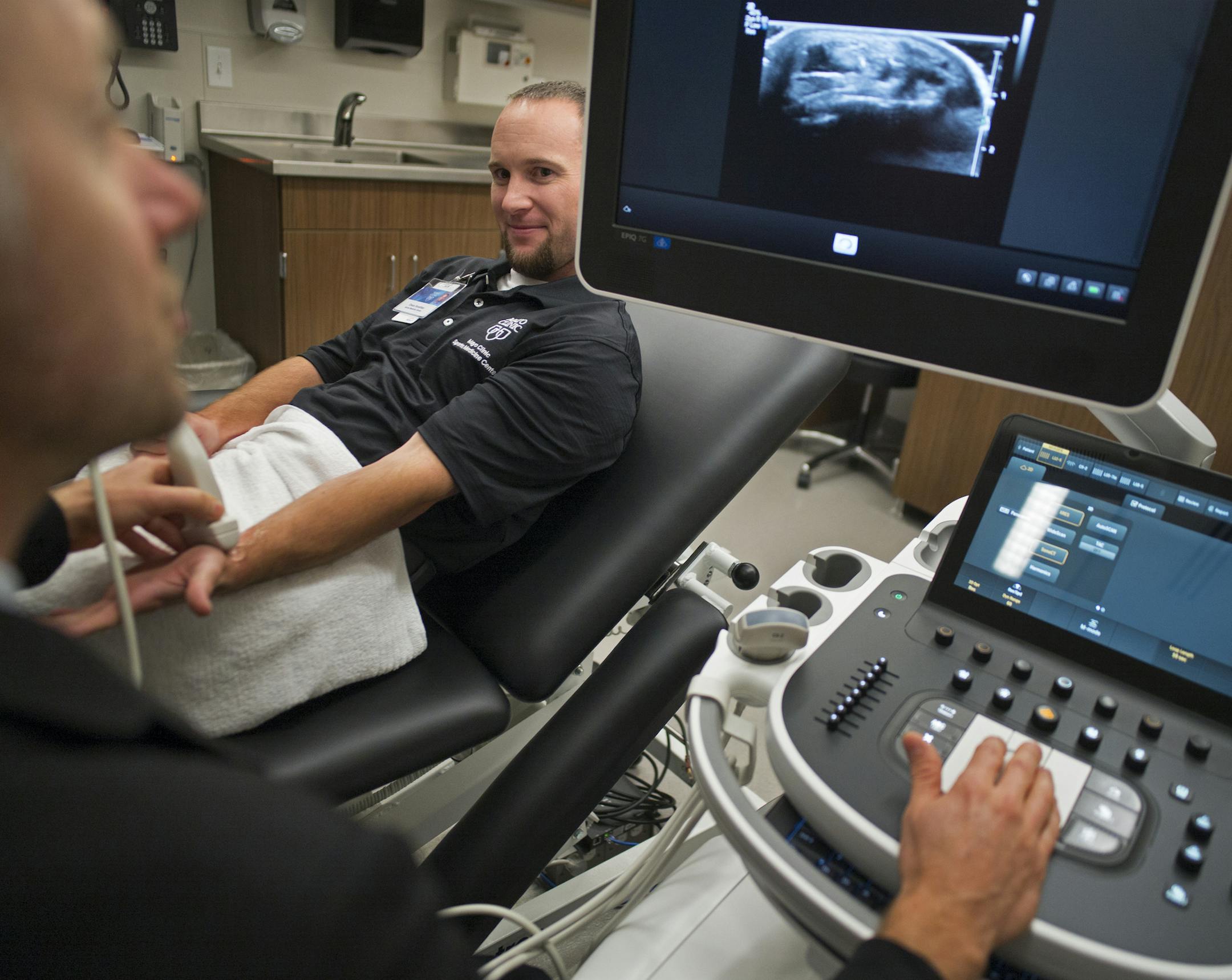 On October 1, 2014, Dr. Jonathan Finoff shows off an ultrasound imager on athletic trainer Chance Donathan. Ultrasound imaging allows for more precise orthopedic surgery and quicker recovery. Mayo Clinic opens its lavish sports-medicine clinic on Hennepin Avenue -- marking a major Twin Cities incursion for the Rochester institution and, perhaps, a promising third life for the woebegone Block E. .]Richard Tsong-Taatarii/rtsong- taatarii@startribune.com